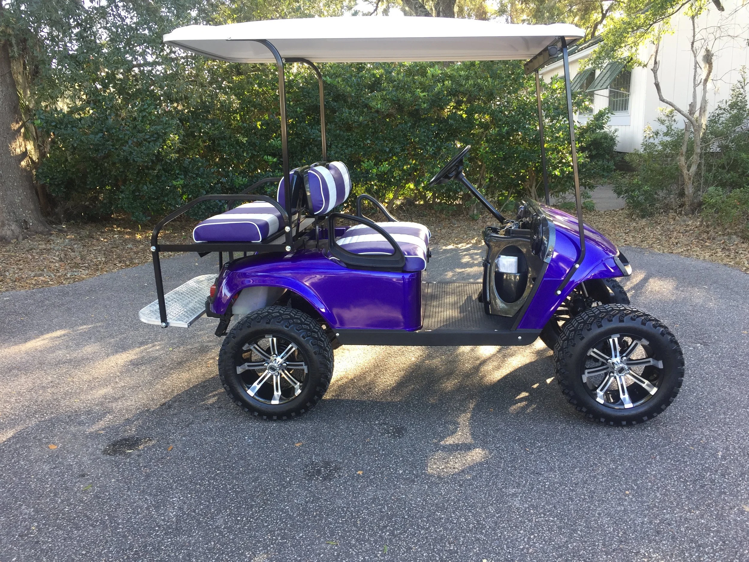 Purple EZGO Lifted Cart Purple/white seats, white extended top, new batteries, high speed code, state of charge meter, LED lights, Backlash (23x10x14) tires, radio and dash package, mirror, and flip windshield