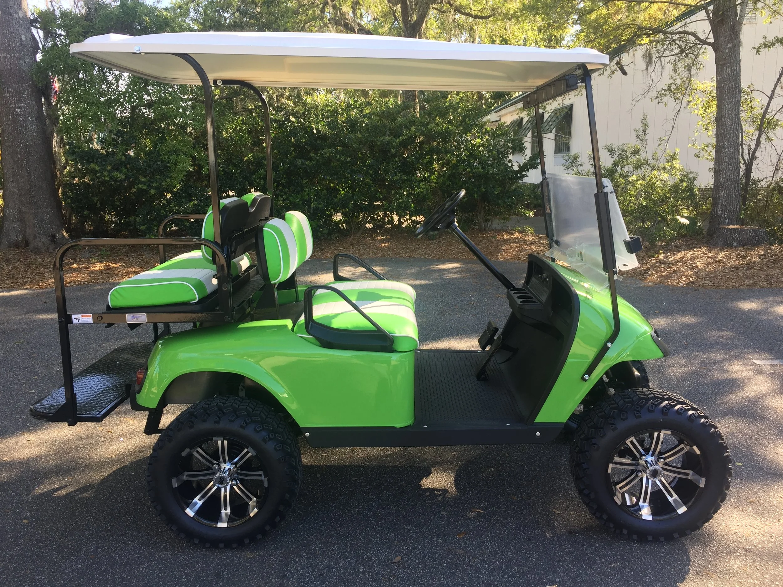 Lime Green EZGO Lifted Cart Lime green/white seats, white extended top, new batteries, high speed code, LED lights, Backlash (23x10x14) tires, mirror, flip windshield, and state of charge meter