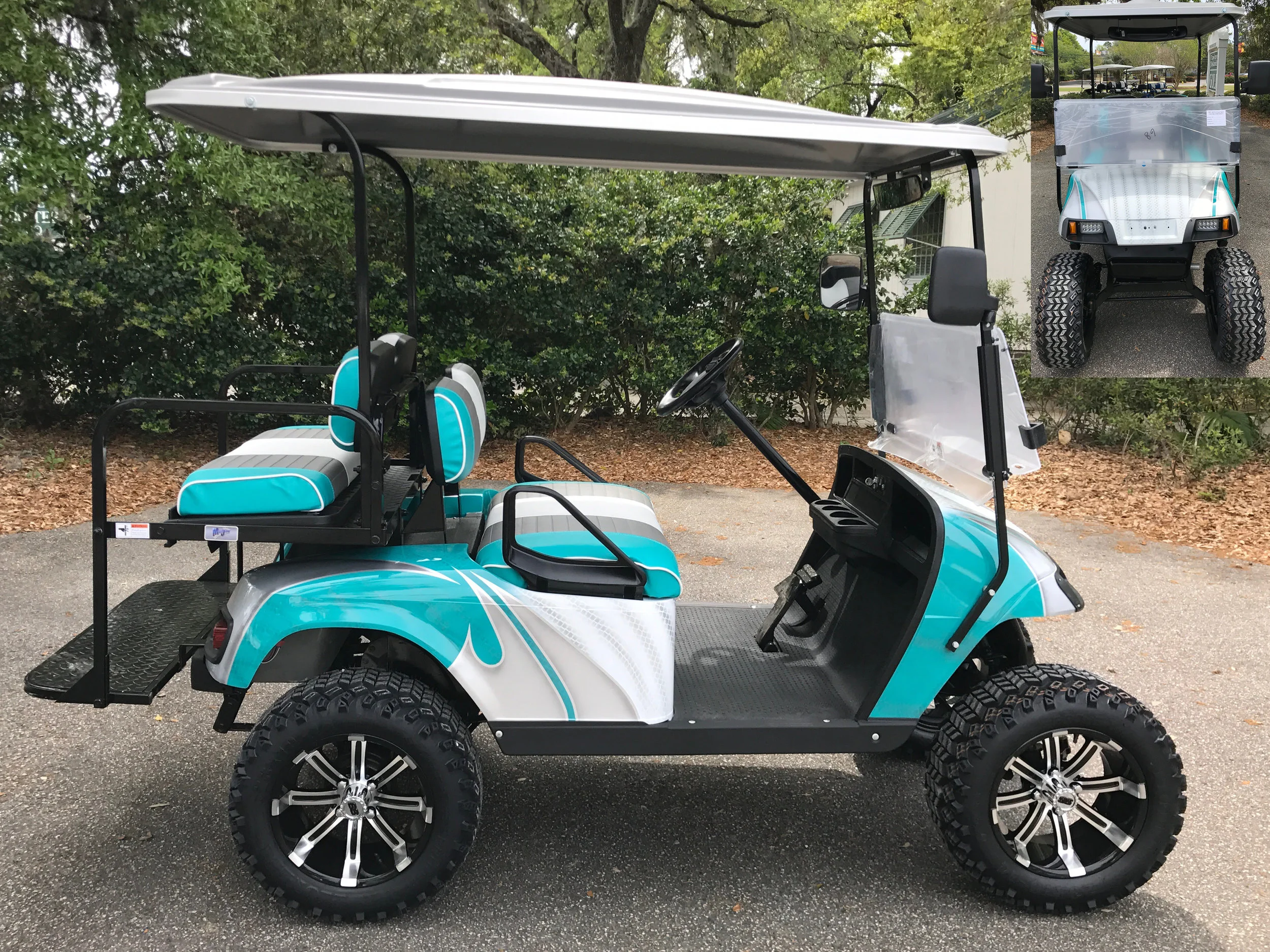 Emerald Swirl EZGO Lifted Cart Emerald/smoke/white seats, gray extended top, new batteries, high speed code, LED lights, Backlash (23x10x14) tires, state of charge meter, rear view mirror, side mirrors, and flip windshield