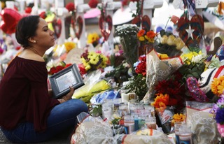 Yamileth Lopez holds a photo of her deceased friend Javier Amir Rodriguez at a makeshift memorial for victims in El Paso, Texas. (Mario Tama Getty Images)