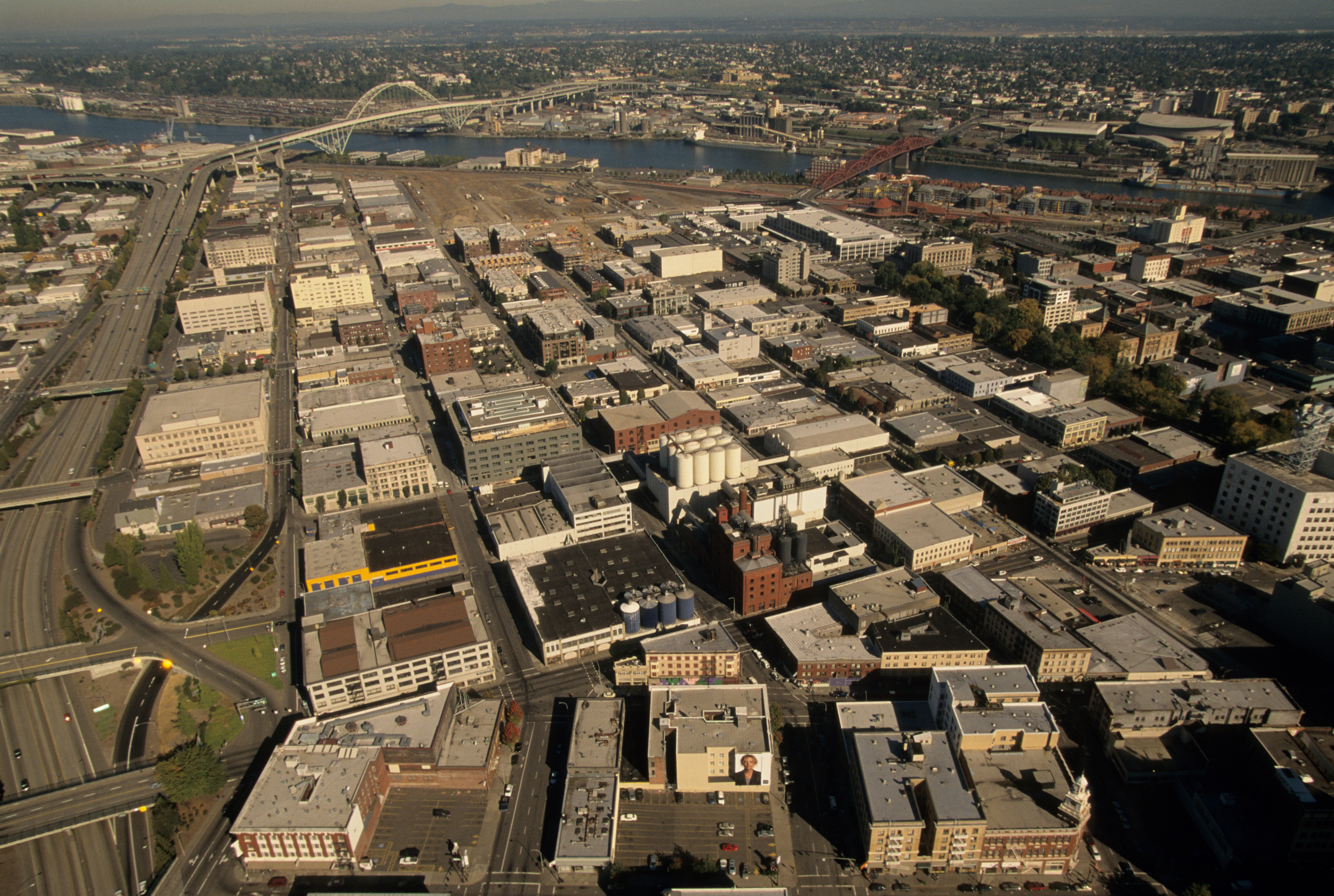 Adaptive reuse of old warehouses continued, but a checkerboard of new city blocks began to sprout mid and high-rise structures.&nbsp; The Northwest Triangle was becoming the Pearl District.&nbsp;Photo by Bruce Forster© 