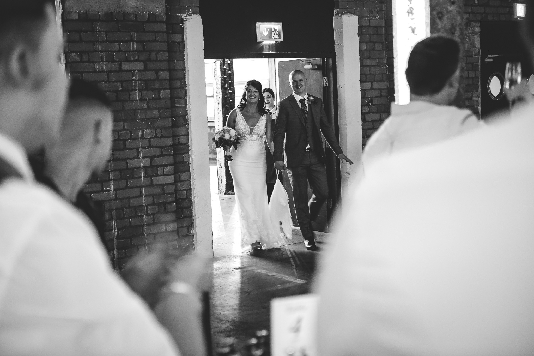 The bride and groom are welcomed to machester wedding venue, Victoria Warehouse