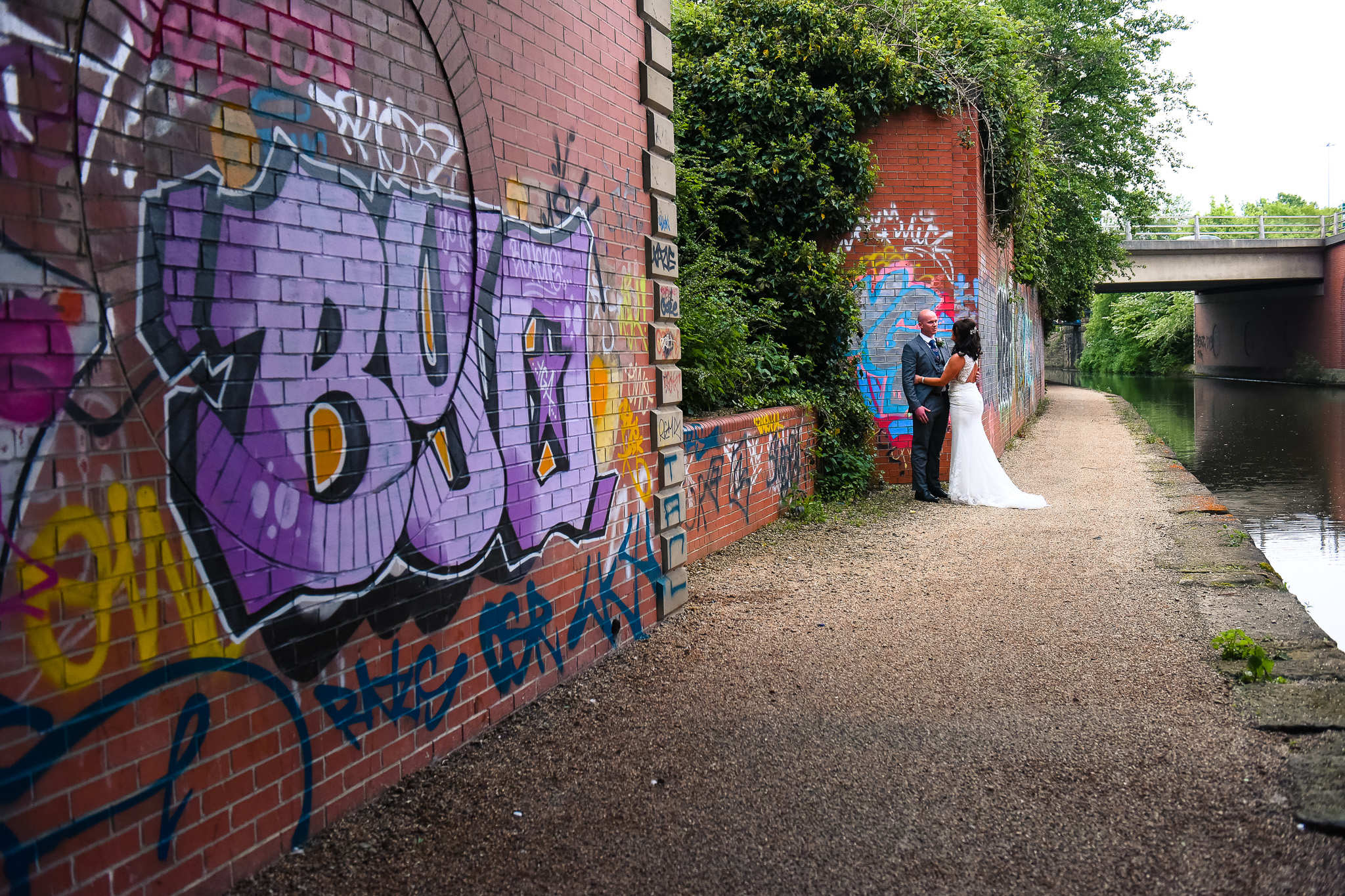 Natural portrait of bride and groom next to Manchester canal
