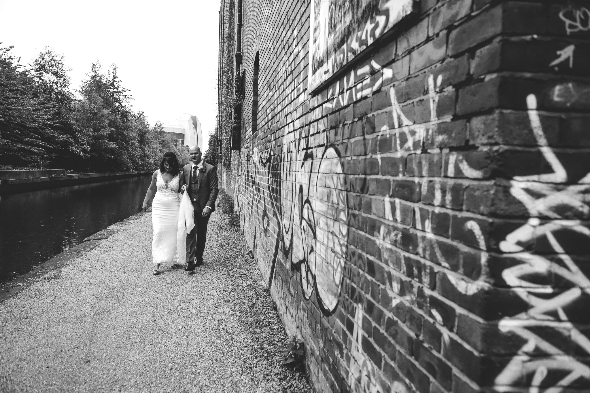 Urban wedding photograph of bride and groom next to Victoria Warehouse