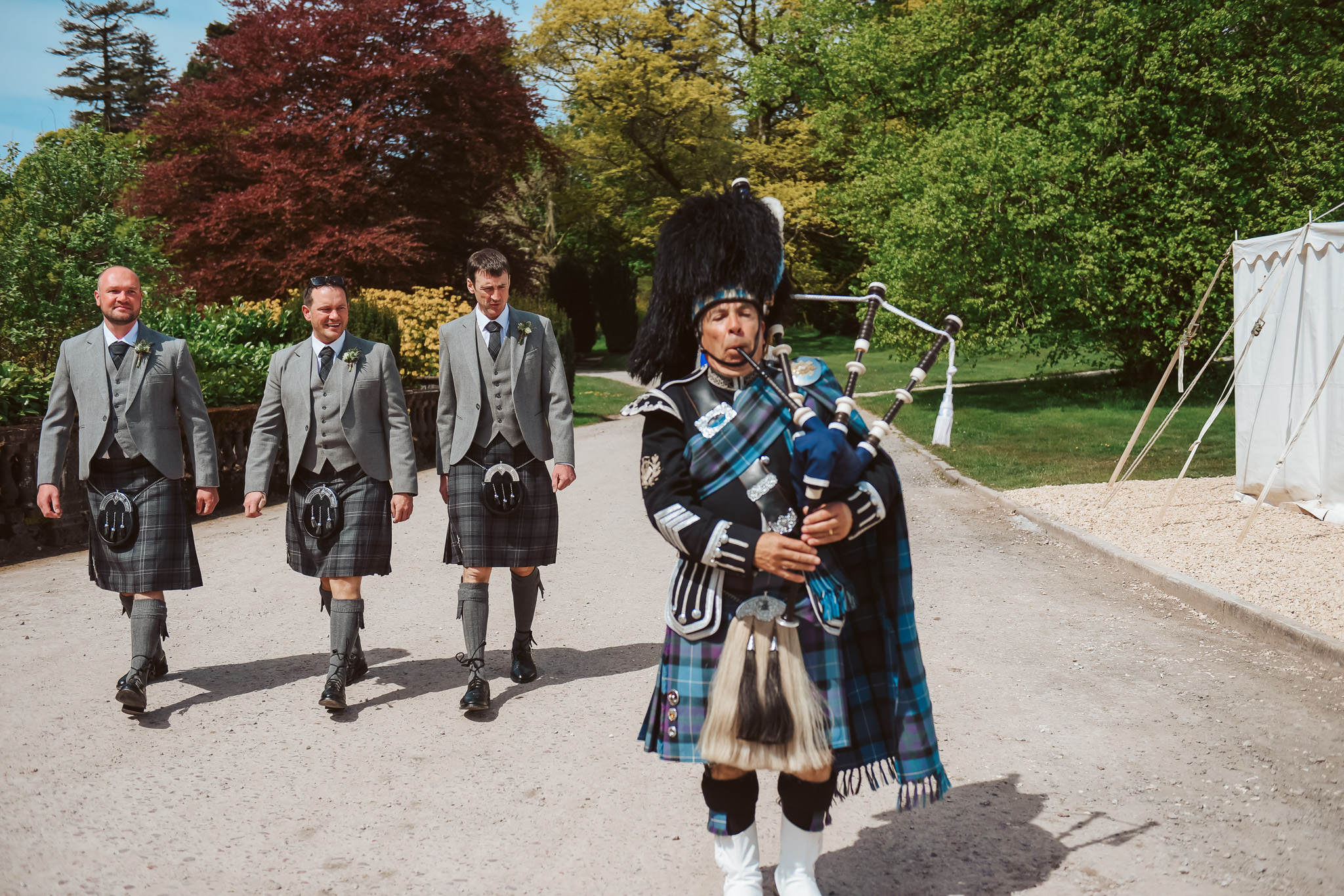 Groomsmen with a Scottish piper