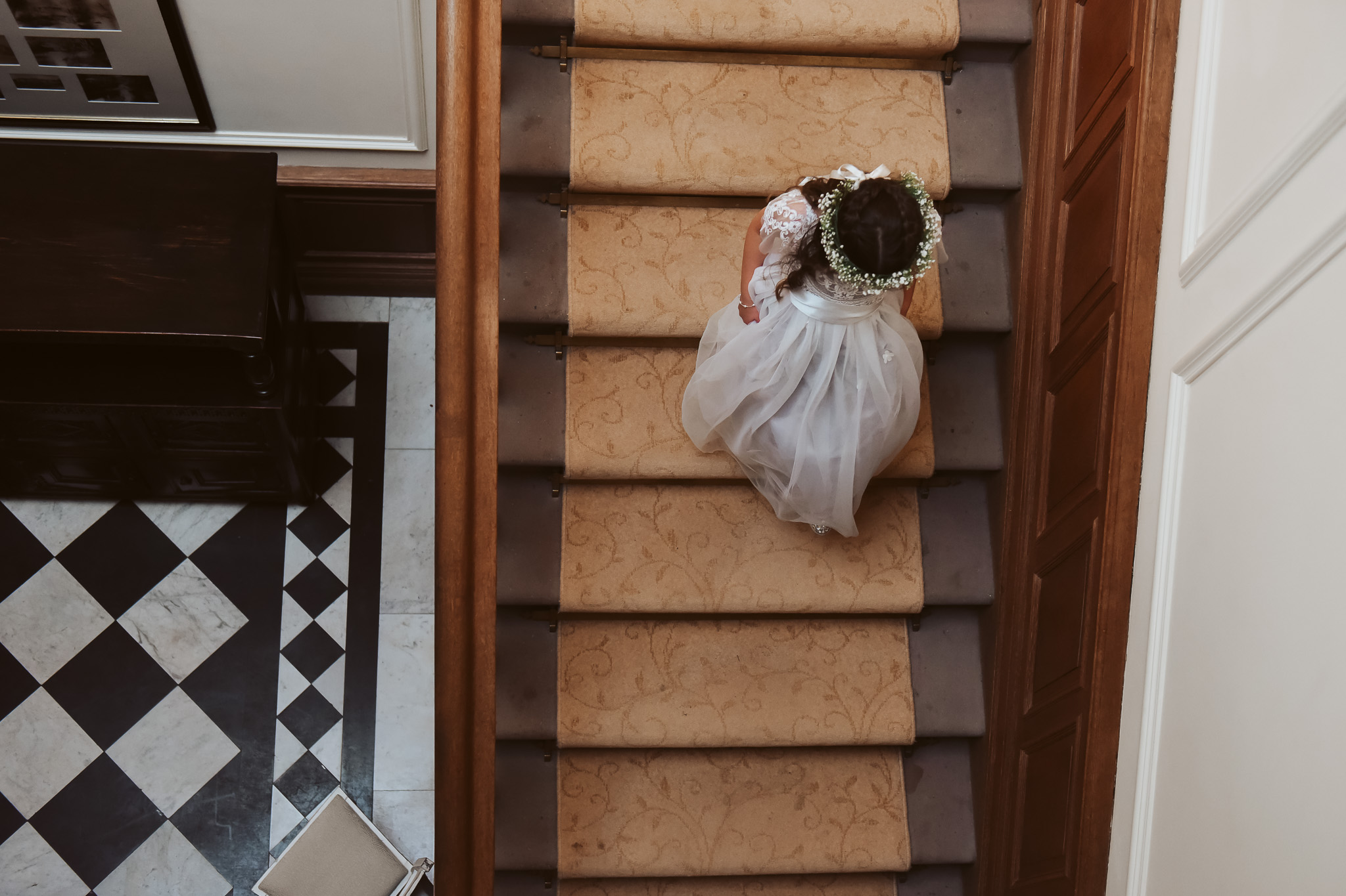 Flower girl makes her way down the grand staircase