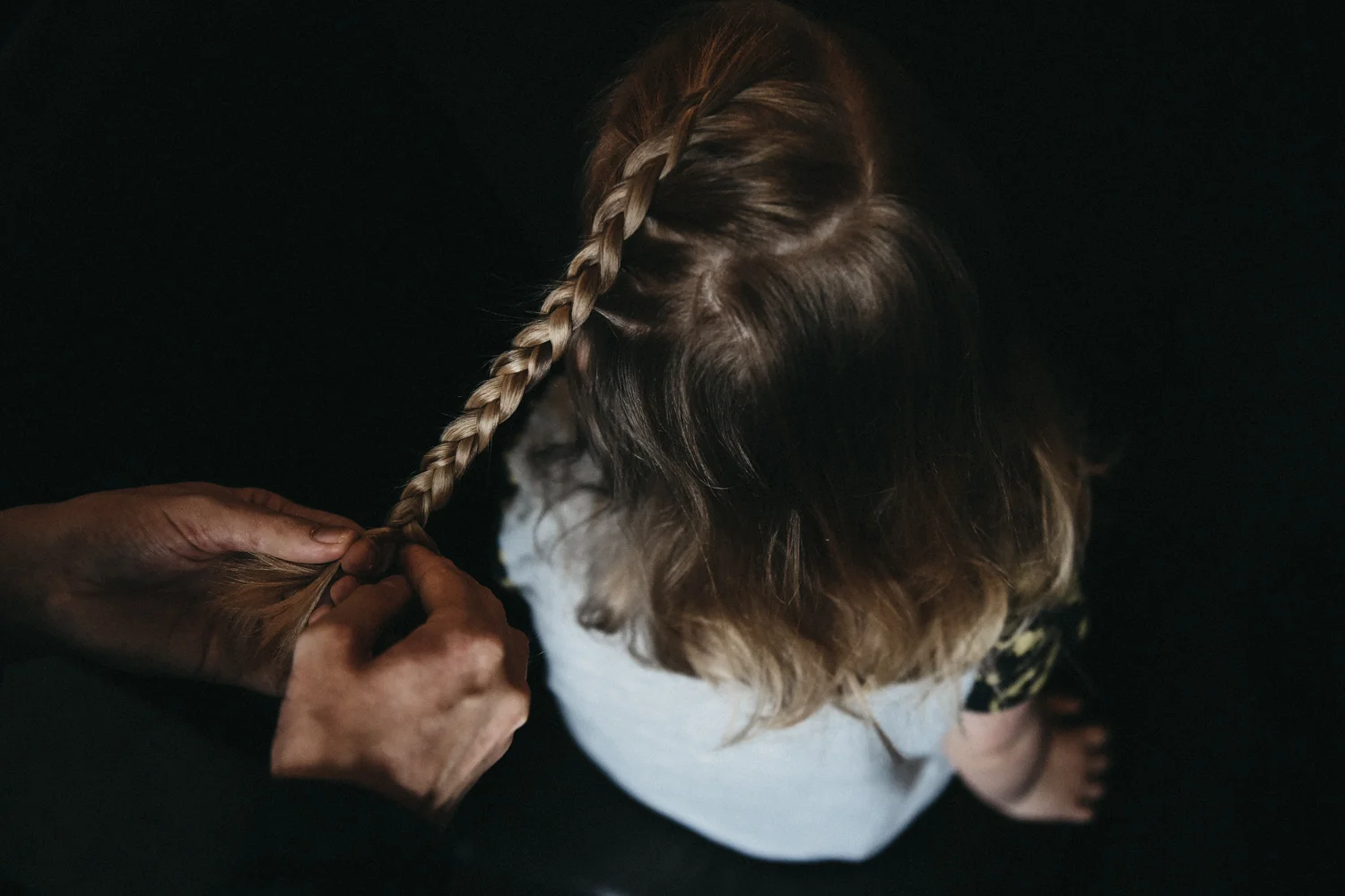 Flower girl having her hair braided