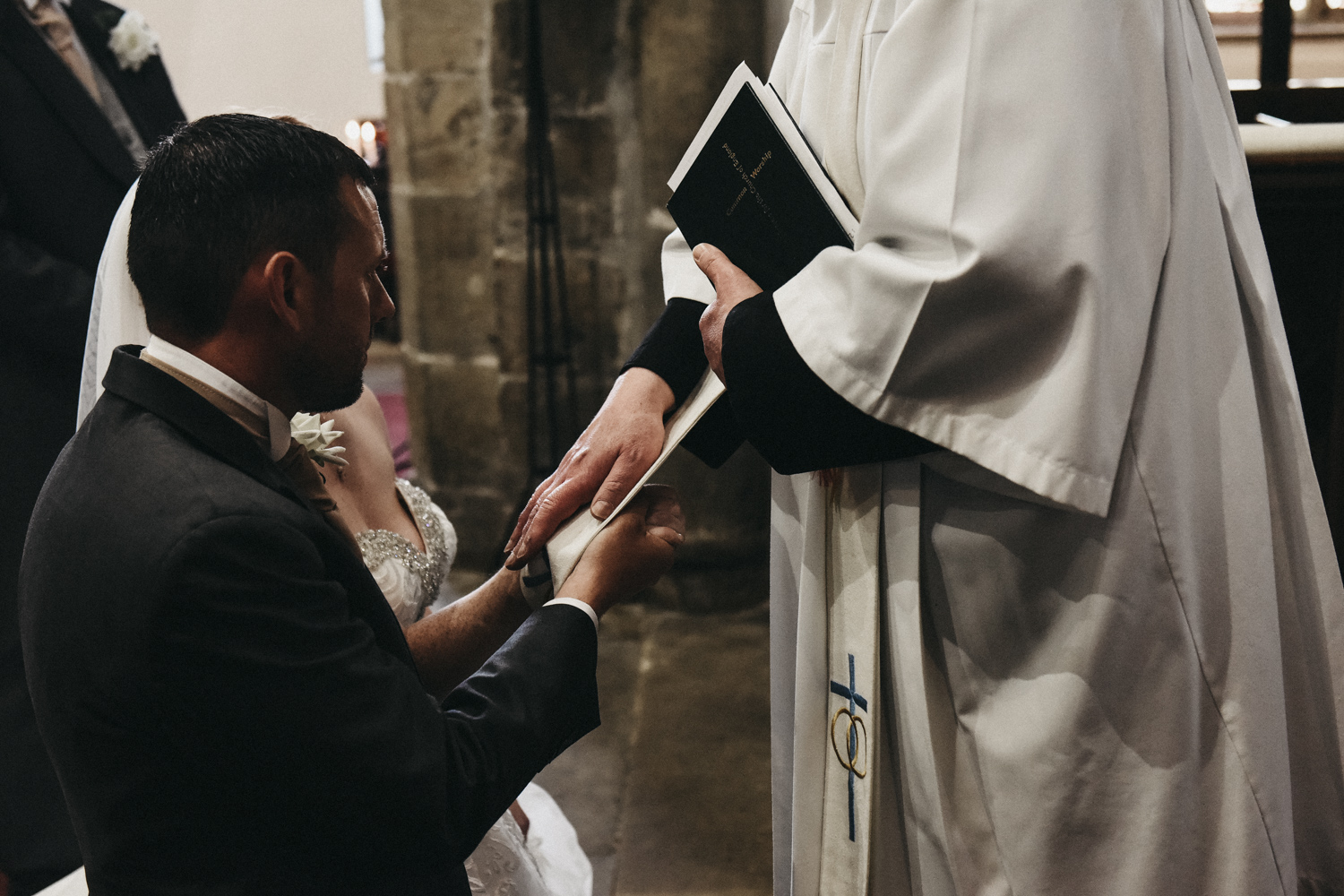 Vicar blessing the married couple