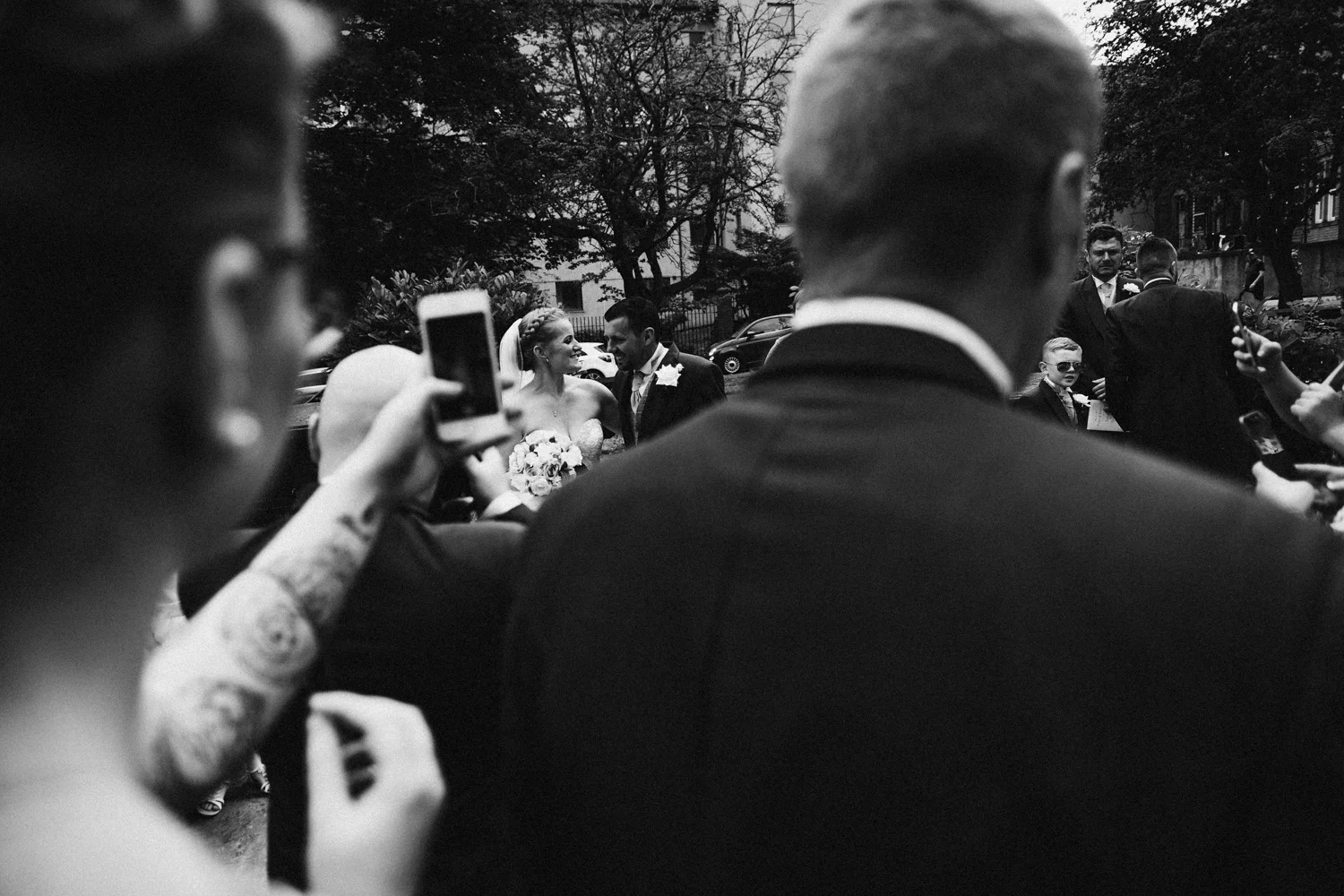 Guests taking photos of the married couple