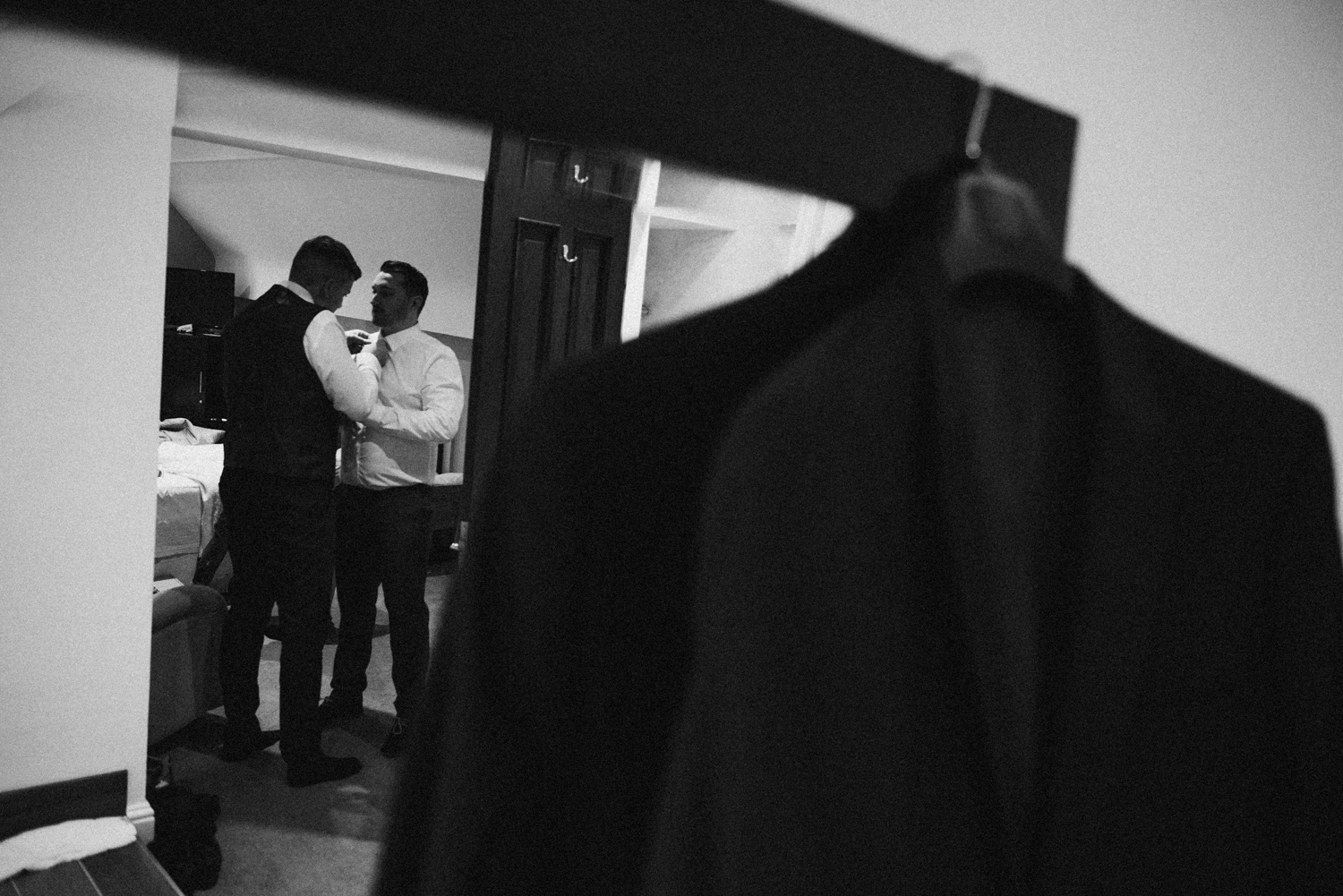 Groom helping the best man to get ready