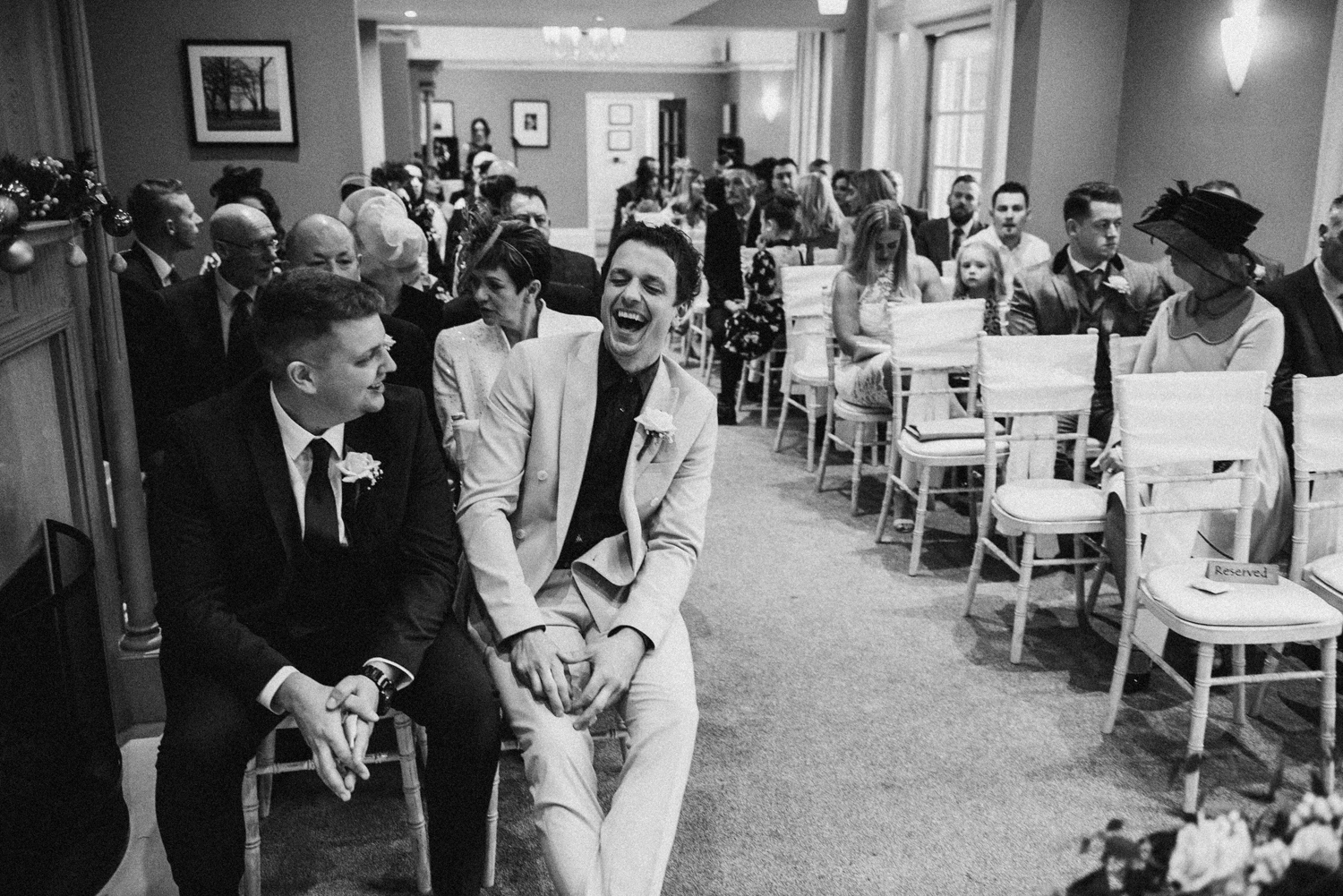 groom and best man laughing