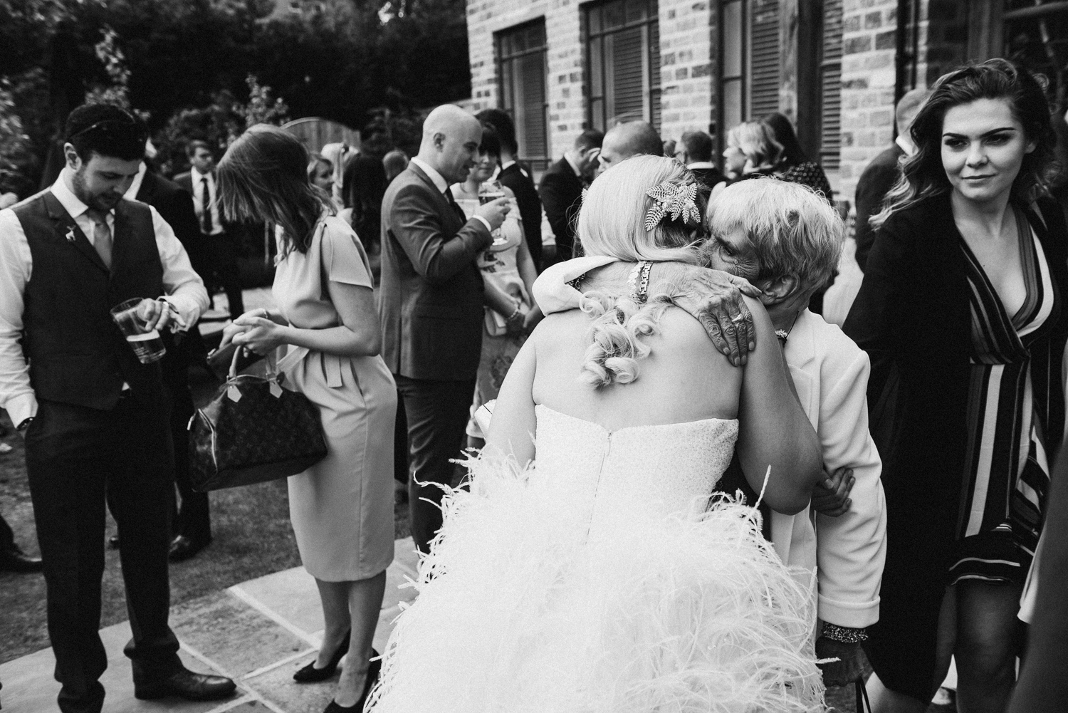 Bride hugging elderly reletive