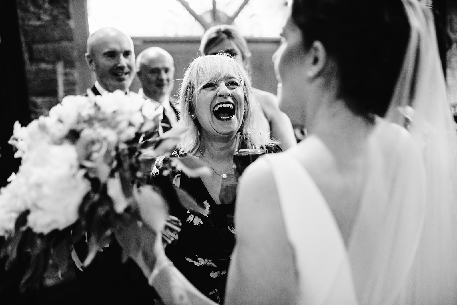 Guests laughing with the couple