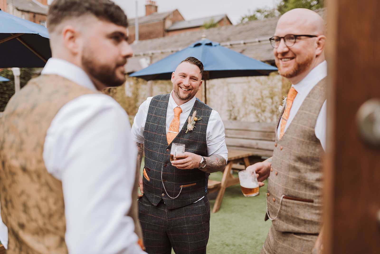 The groom laughing with friends