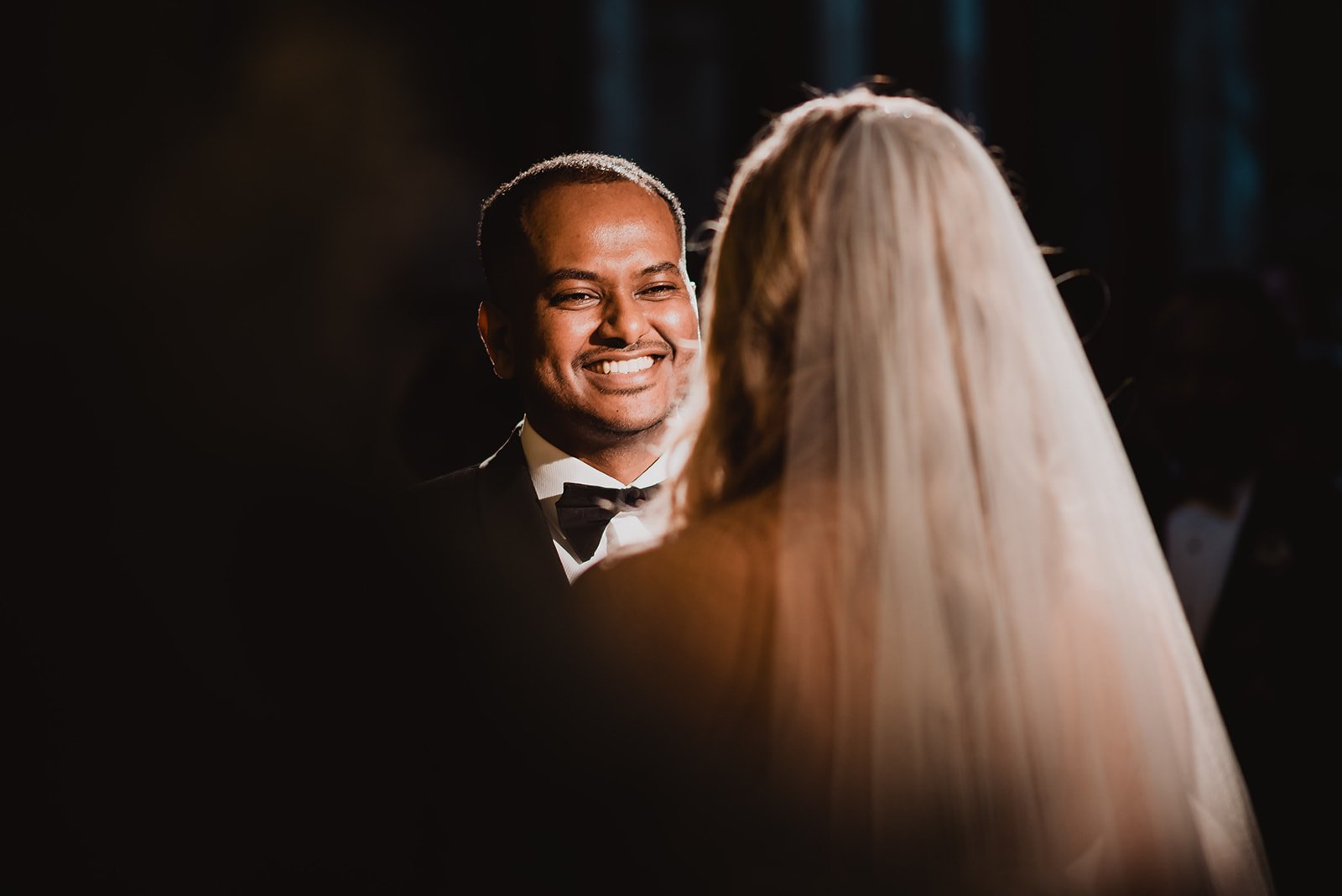 The groom laughing during the ceremony