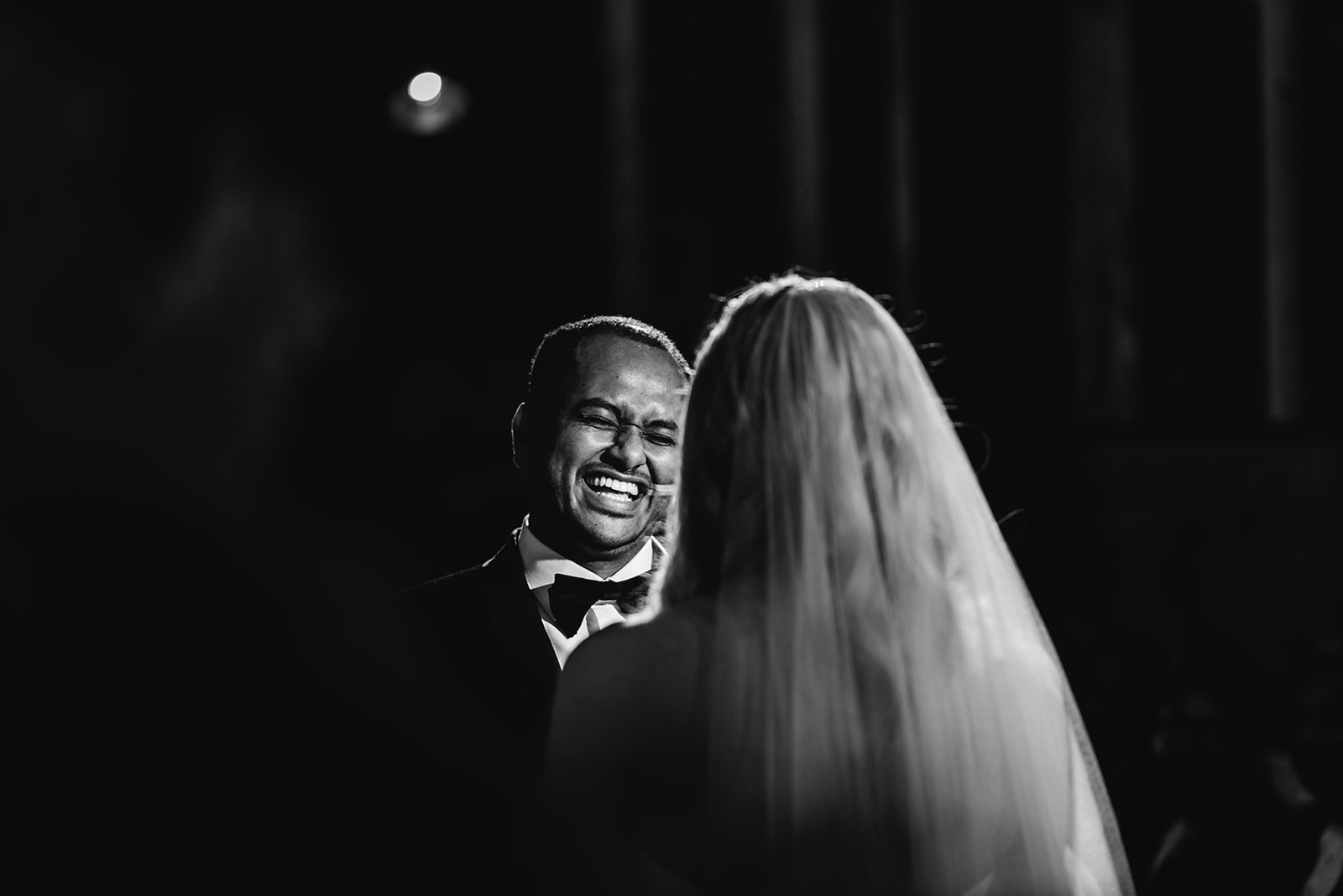 Groom laughing with his bride