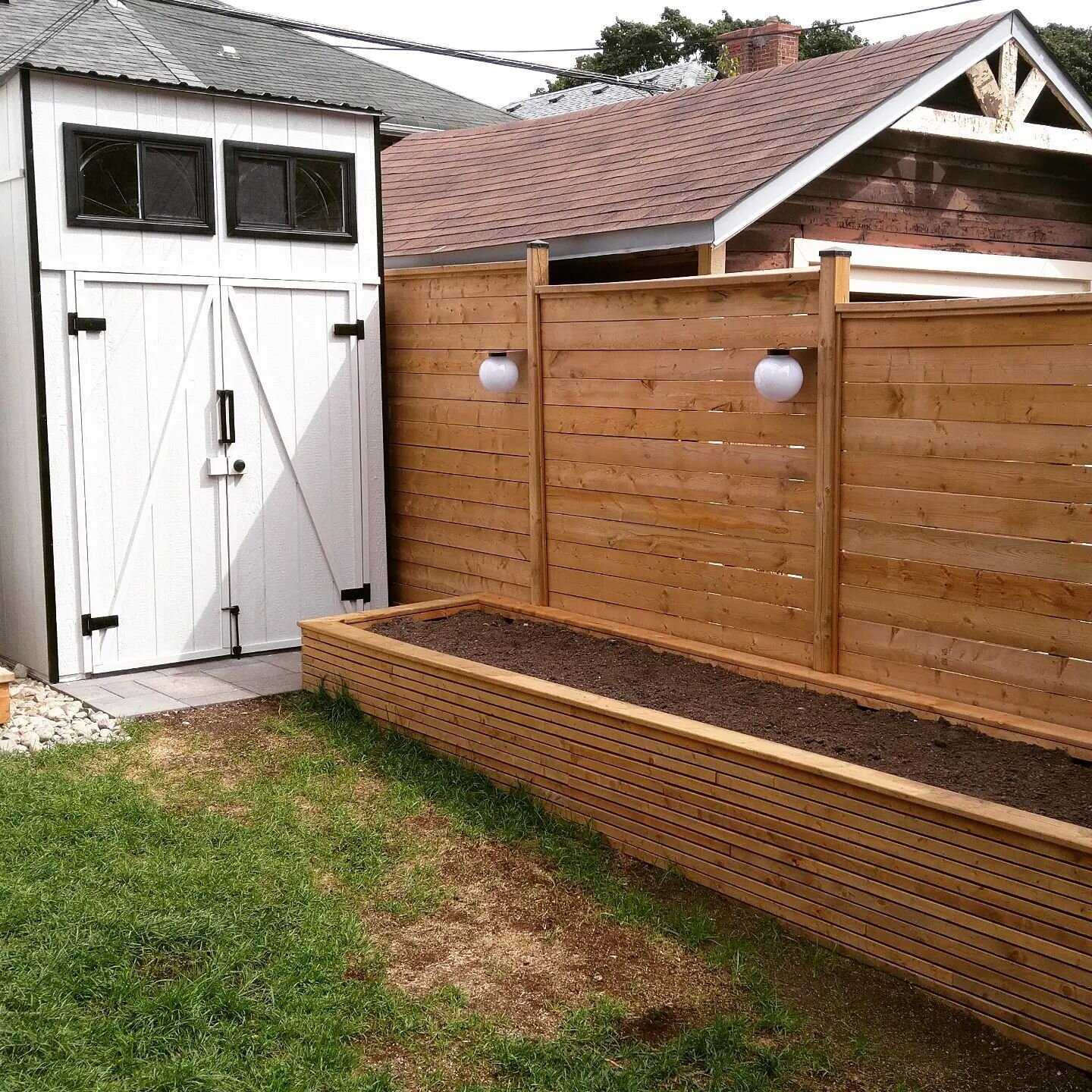 Custom storage shed, planter box &amp; fence utilizing the space in this small but very functional back yard