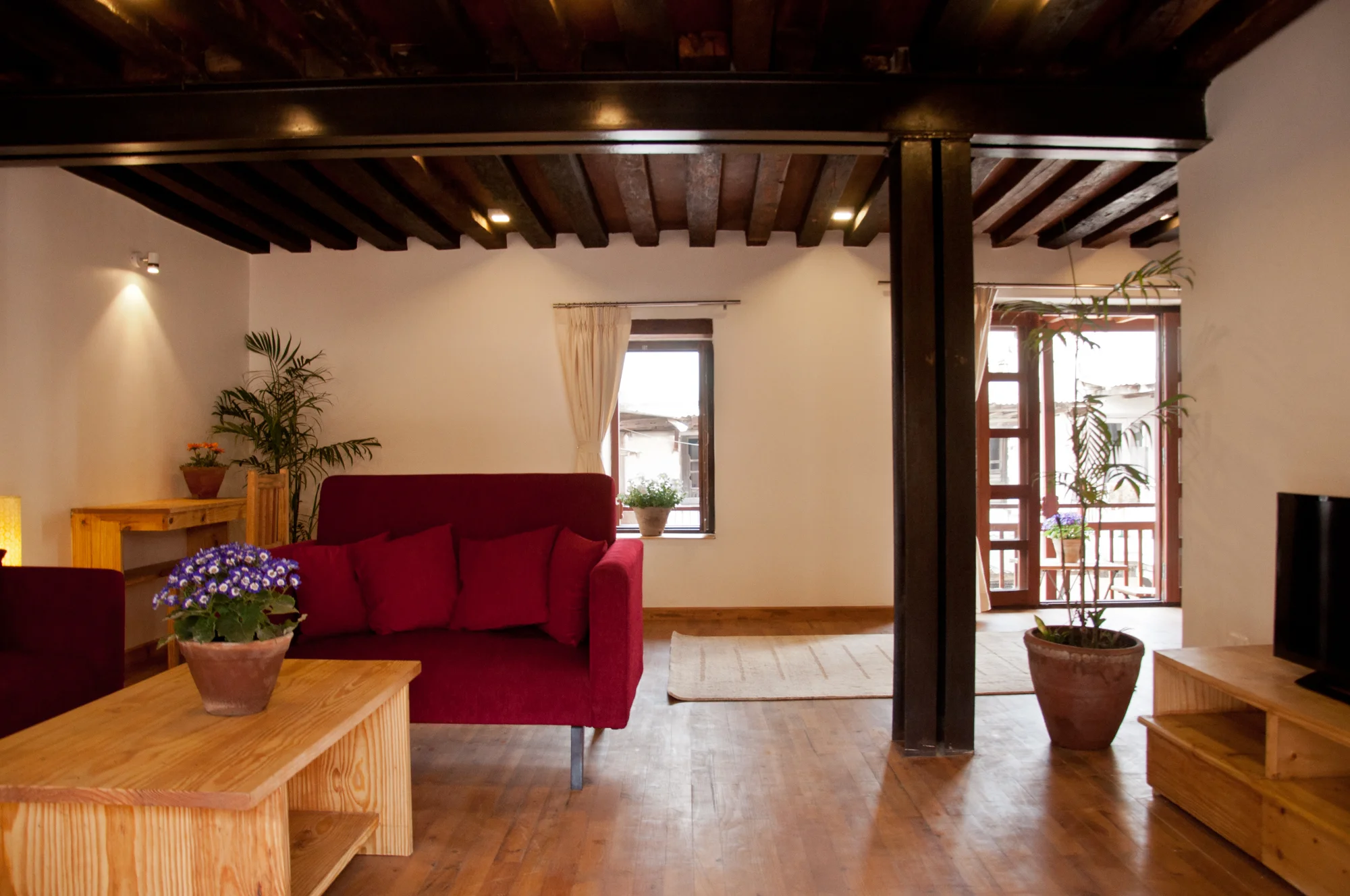Living room with sofa set, working space, balconies