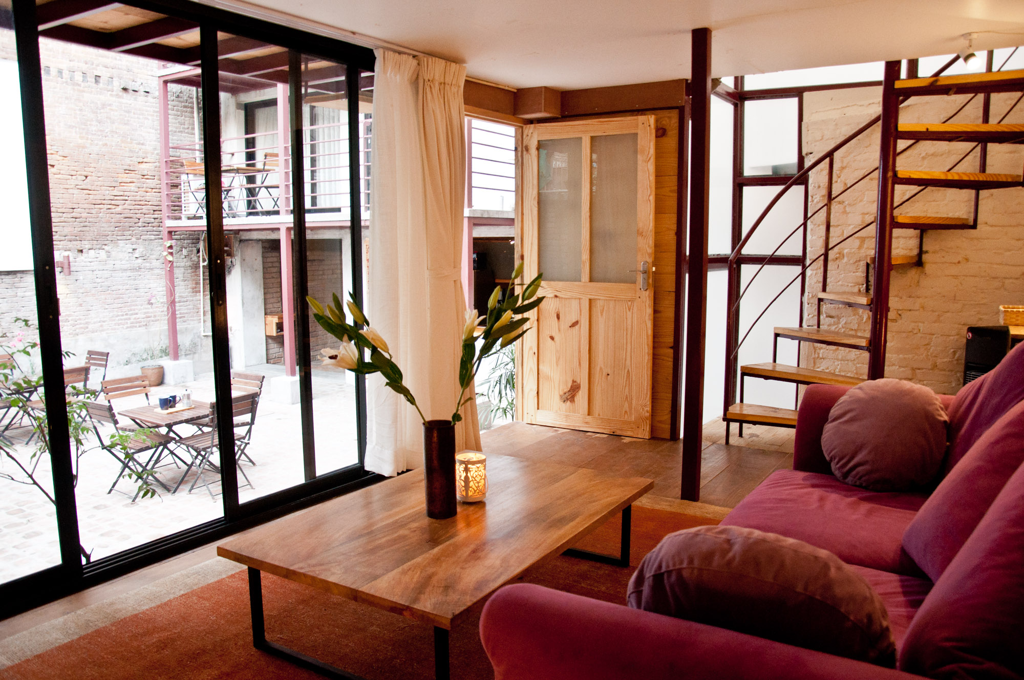 this is a living room in courtyard cottage on the back staircase that leads to bedroom.
