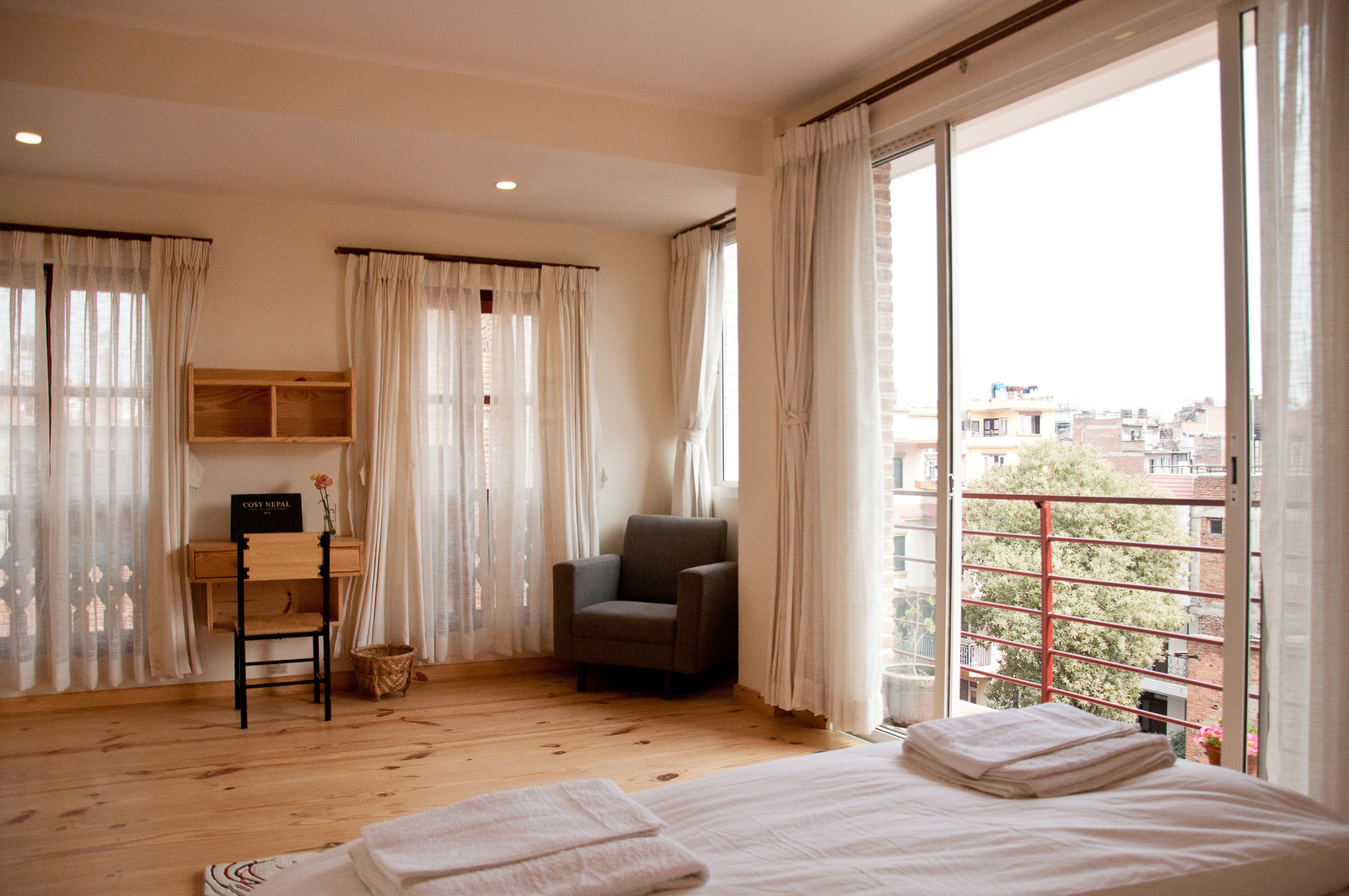 Balcony, computer table and armchair in bedroom.