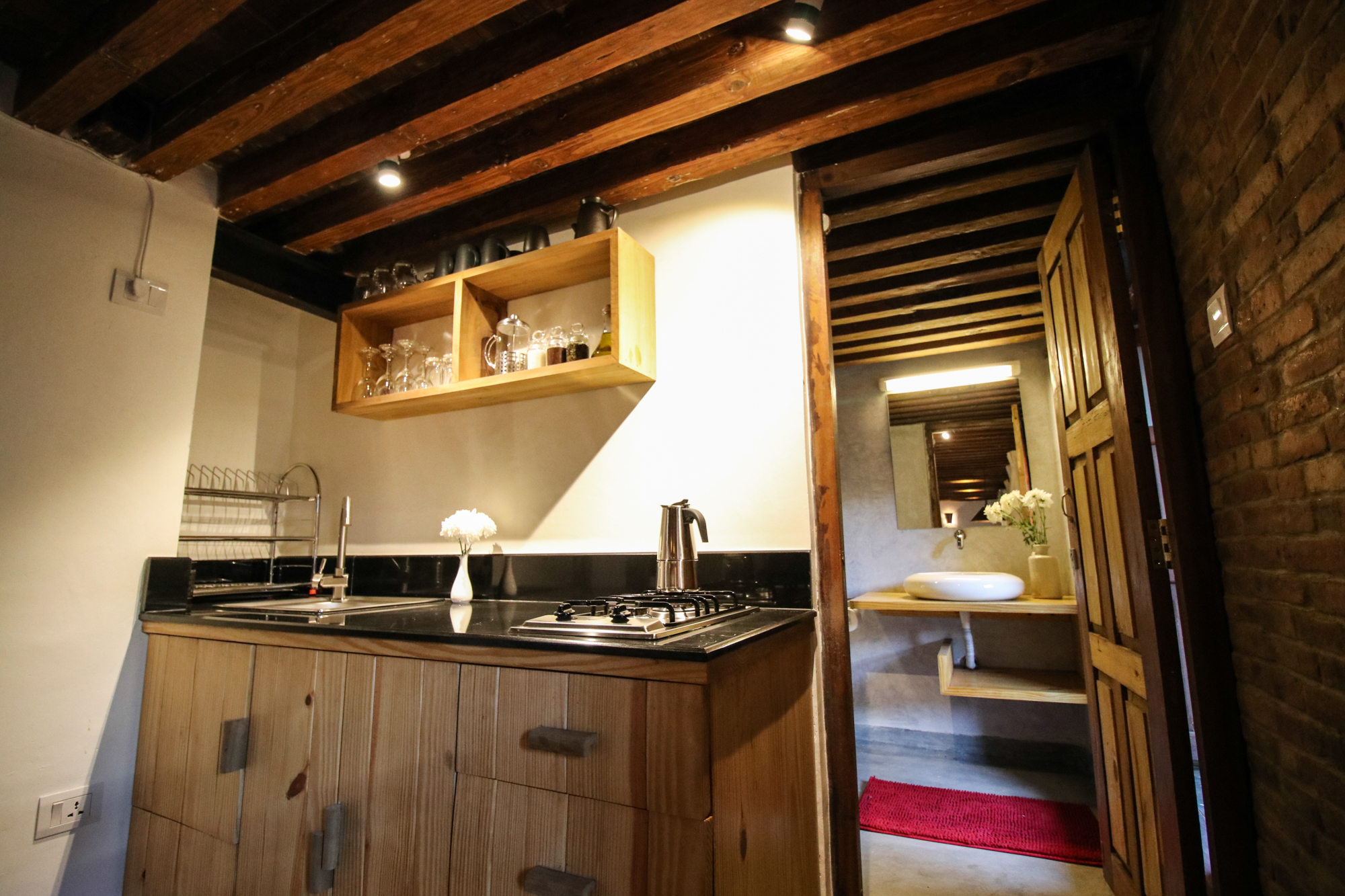 Fully equipped kitchen on left and entrance door to bathroom to the right.