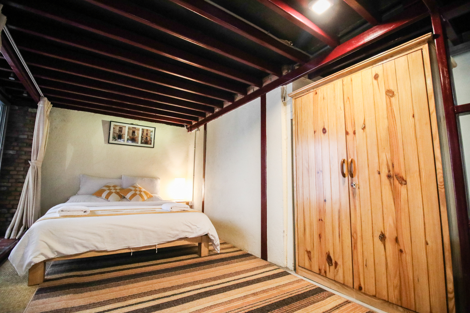 Guests can store their clothes or valuables in wooden cupboard.