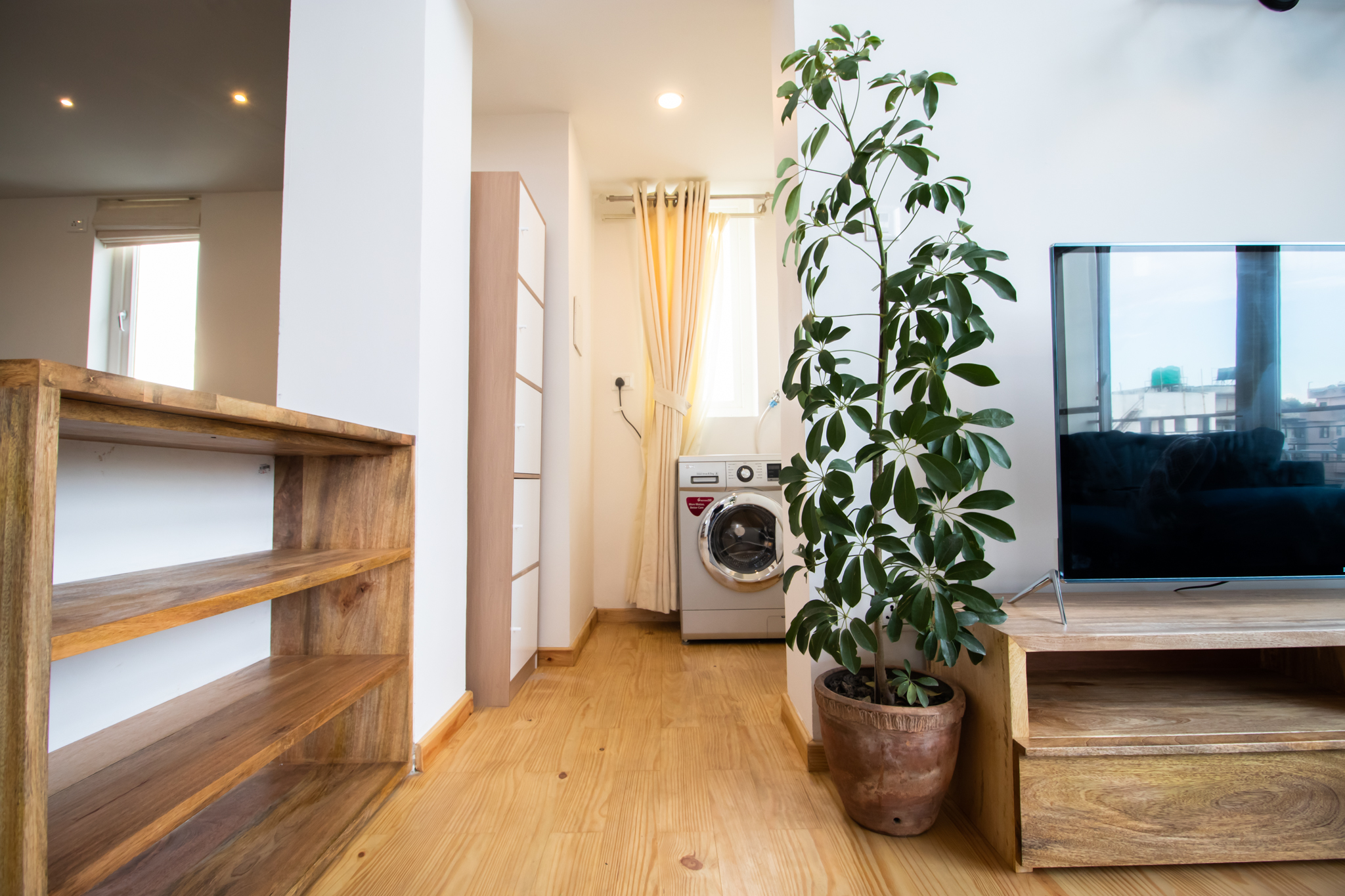 A wooden cupboard on the left and just opposite is the restroom.