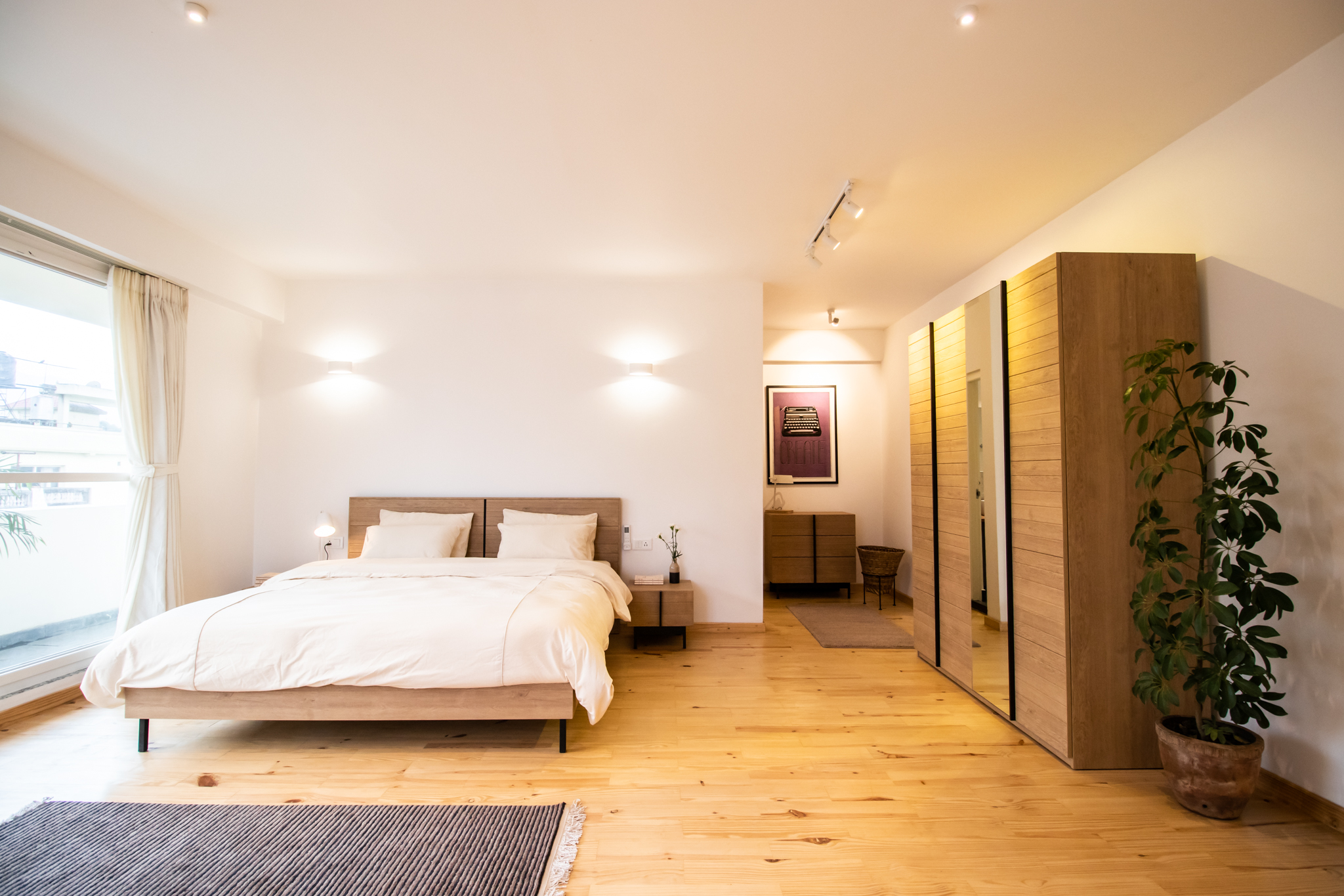 Master bedroom with wooden cupboard to hang your clothing sets.