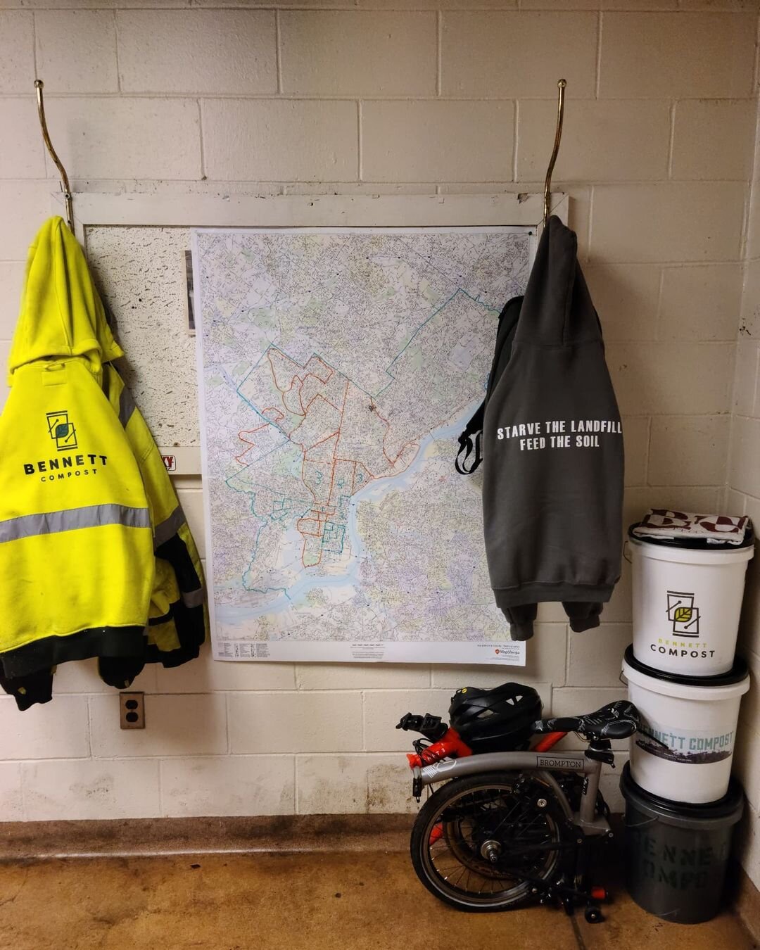 What we do, all wrapped up into one pic:⬇️
.
Three buckets from over a decade of evolution, a fold up bike for daily travel to and from our spot on Rising Sun Ave., our bike routes maps, a hi-vis hoodie for the road, and one for the office with our m
