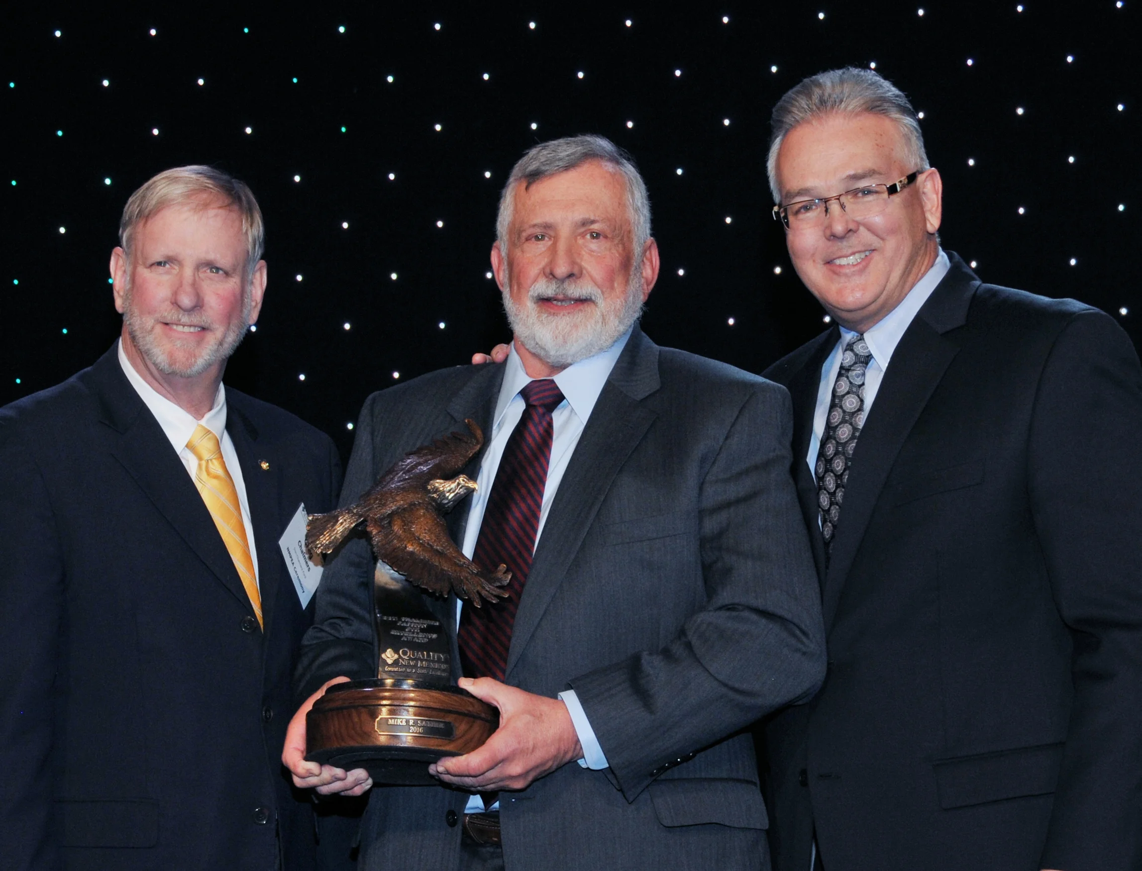 Dr. Mike Sather (photo center) was the first recipient of the award. Greg Chalmers (left) and Steve Keene (right) presented the award at the 2016 Learning Summit.&nbsp;