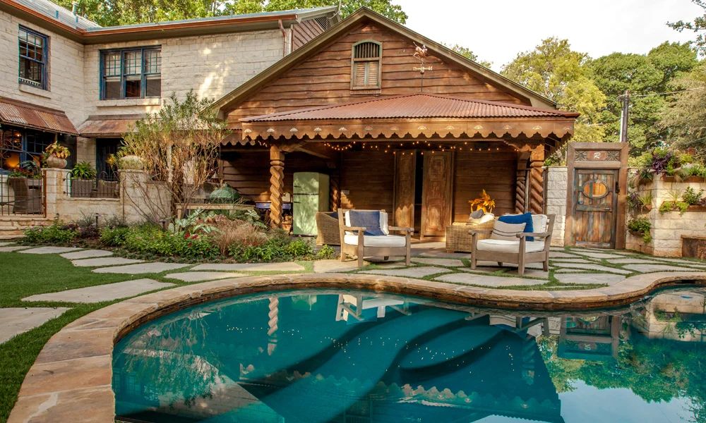 The homeowners strategically chose to open up the third car bay in their garage to create a small covered outdoor patio. While not as extensive as some of our other outdoor living projects, the homeowners invested their budget in creating the specific French country house design that was important to them.