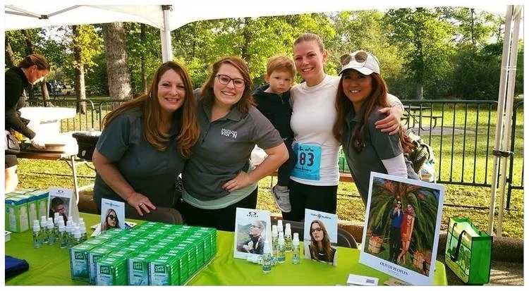 MPV's amazing staff working the booth and passing out contact lens solution at the Memorial Park Run. 