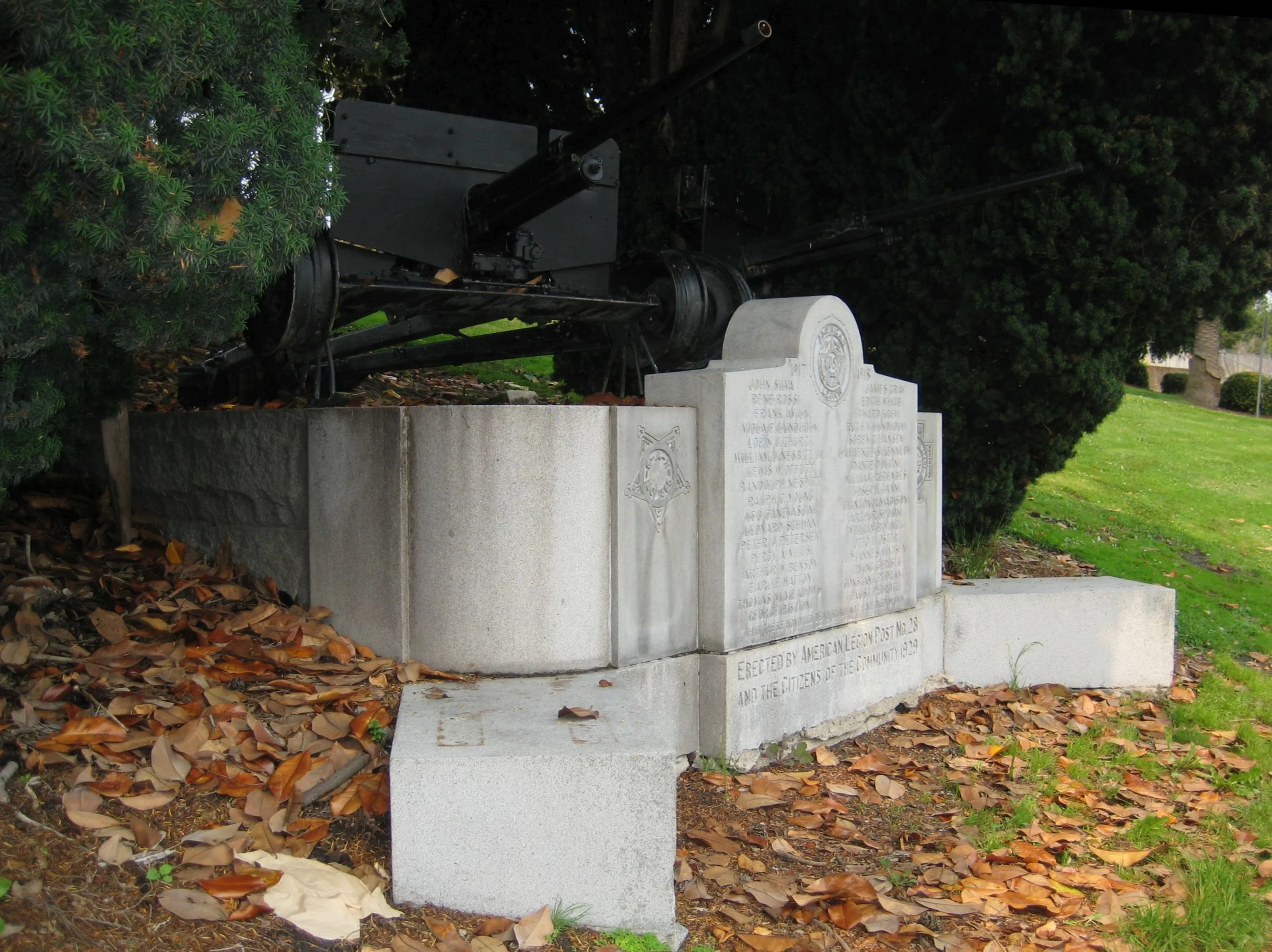 The WWII Memorial is partially obscured by nearby yews. Photo by Janet Gracyk.