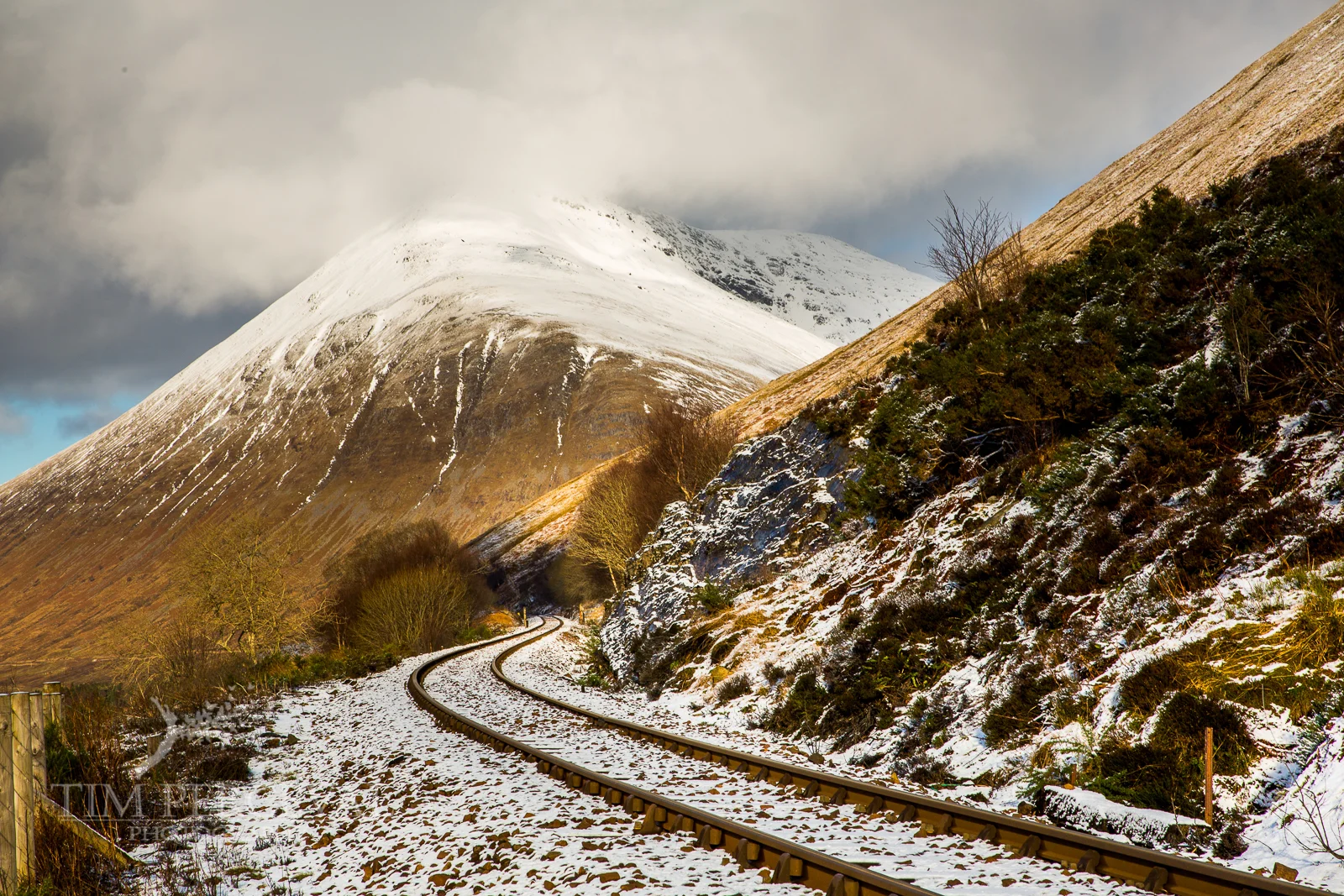 Snowy railroad past Beinn a Chaisteil and Beinn Dorain