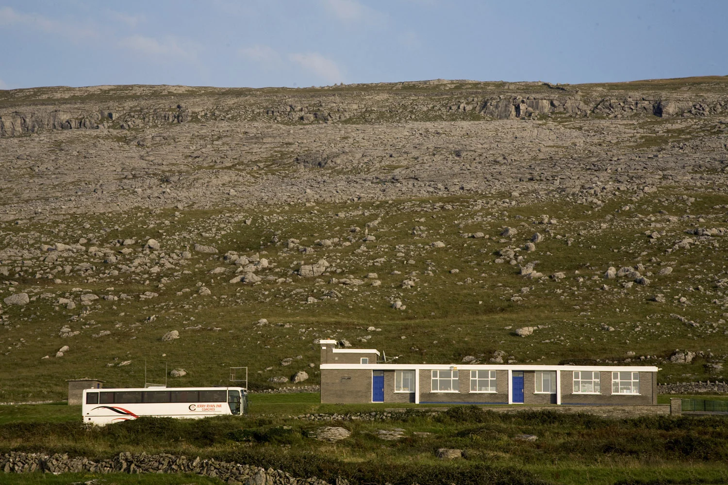 A bus drives through the burren in the west of ireland