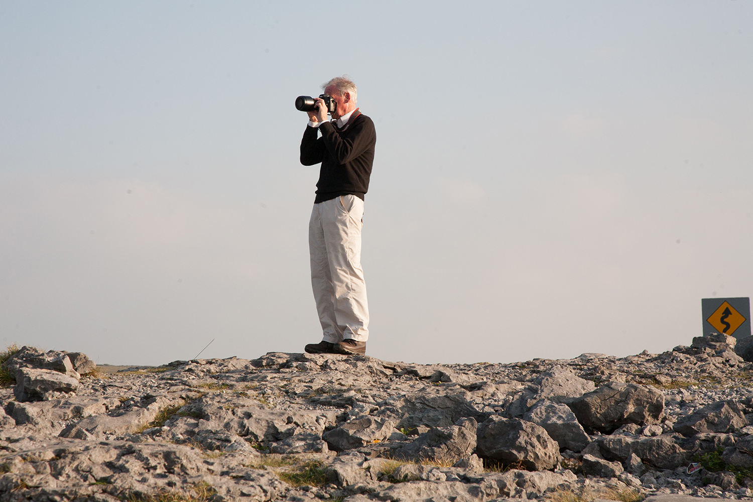 A documentary photograph of a man taking photograph of the Burren in the West of Ireland