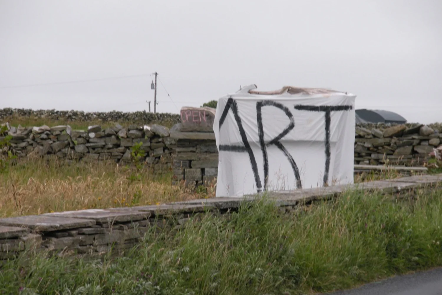 A documentary photograph of a sign promoting art in the west of ireland