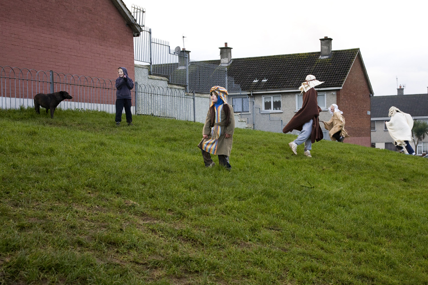 A documentary photograph of boys playing before the perform a live nativity scene with the monks of Moyross in Limerick City