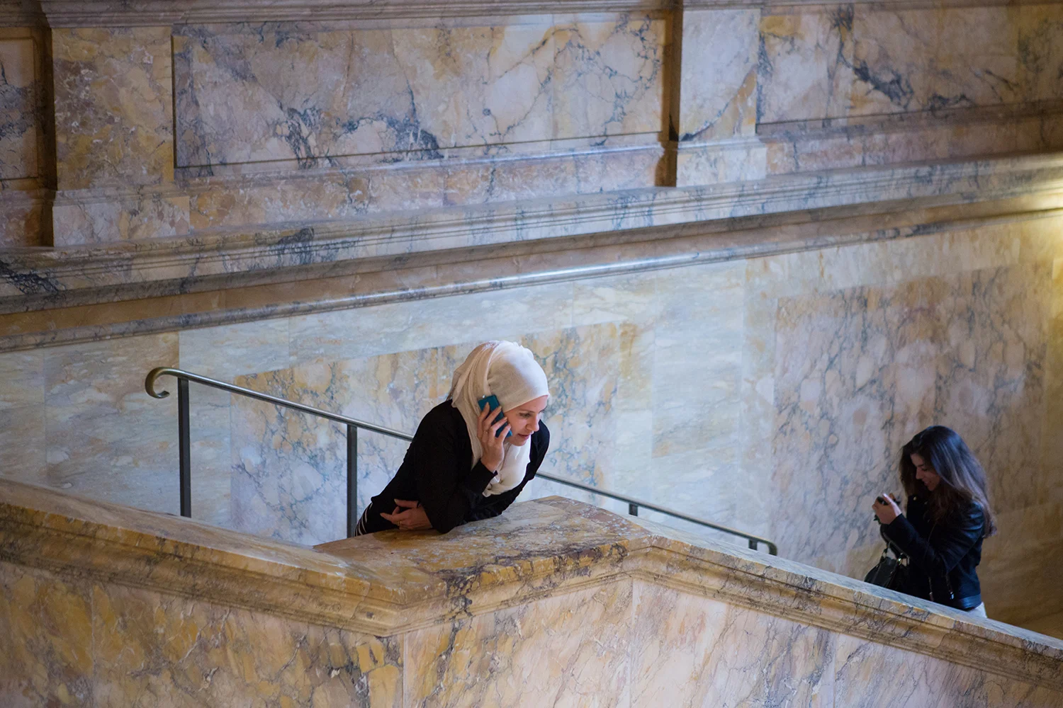 A documentary photograph of woman on their phones at the Boston Public Library