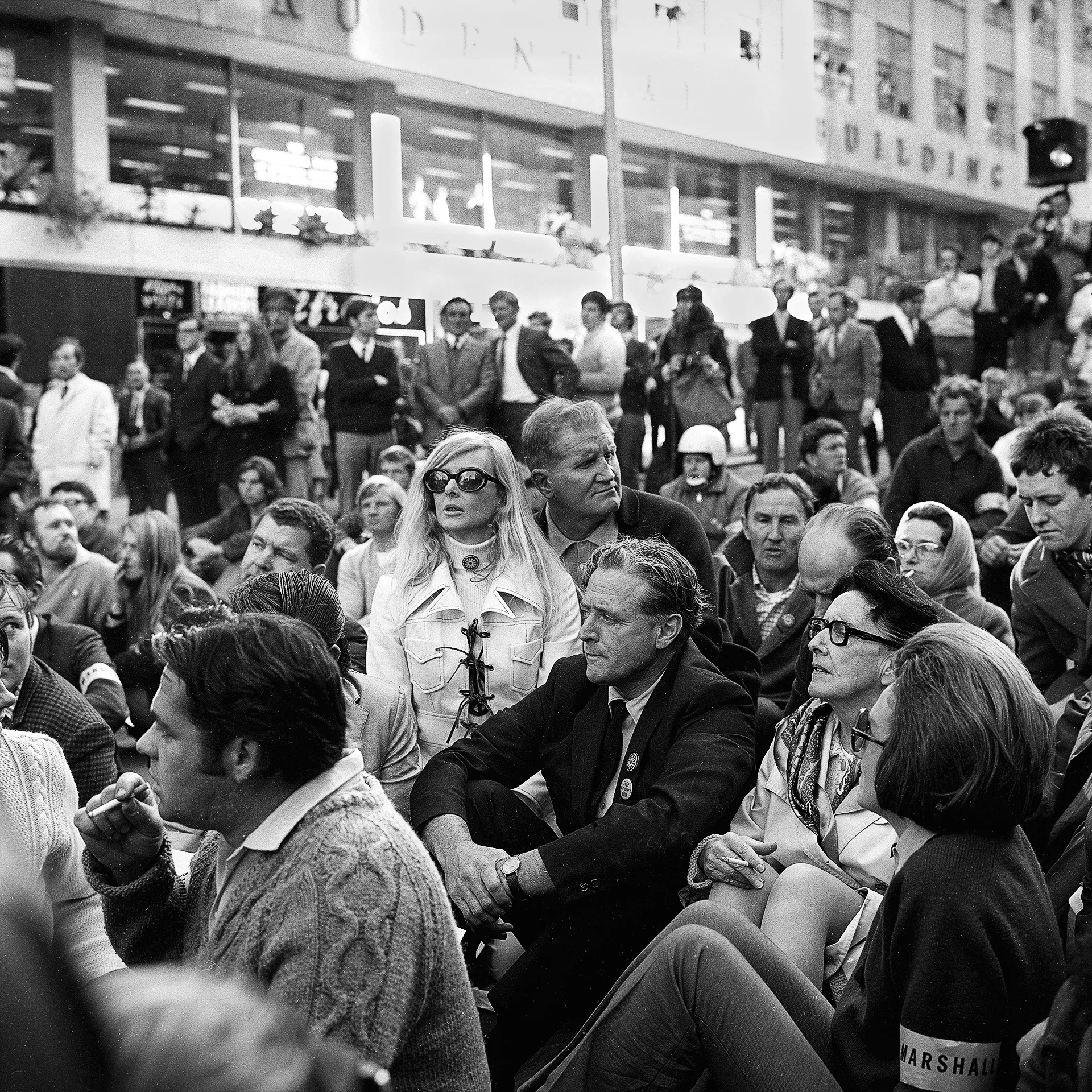 Deputy Prime Minister Jim Cairns seated with protesters.