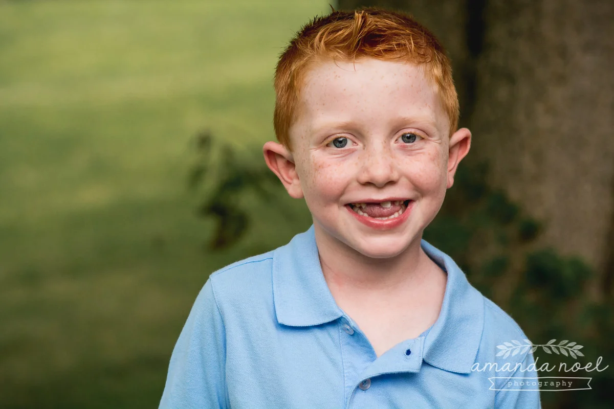 redhead-boy-in-blue-portrait-outside-freckles