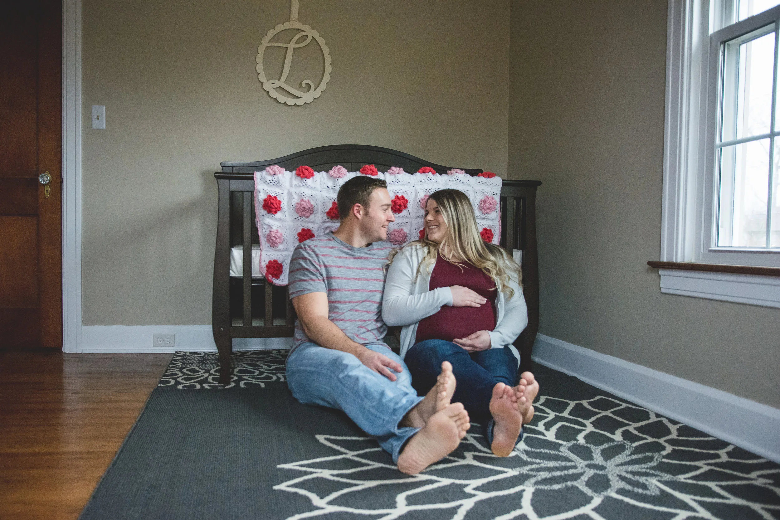 Columbus Ohio maternity photographer fun couple in baby nursery