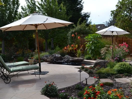 Patio with custom spa and flowery garden