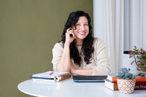 Yasmine Binghalib, LMFT, smiling at a table