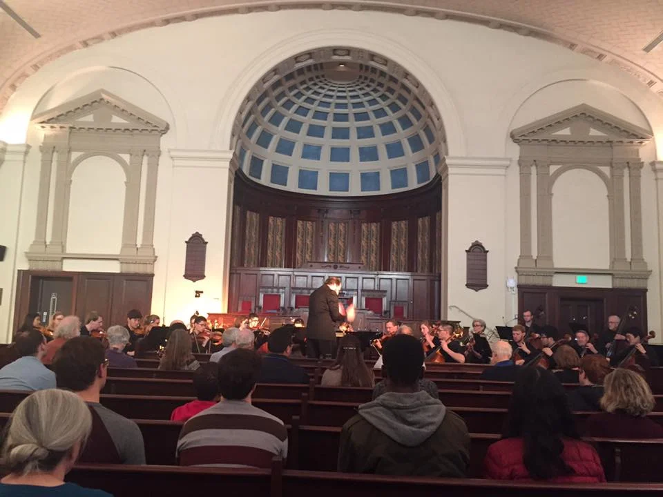 Jordan Randall Smith conducts the Hopkins Concert Orchestra at the Johns Hopkins University Interfaith Center.
