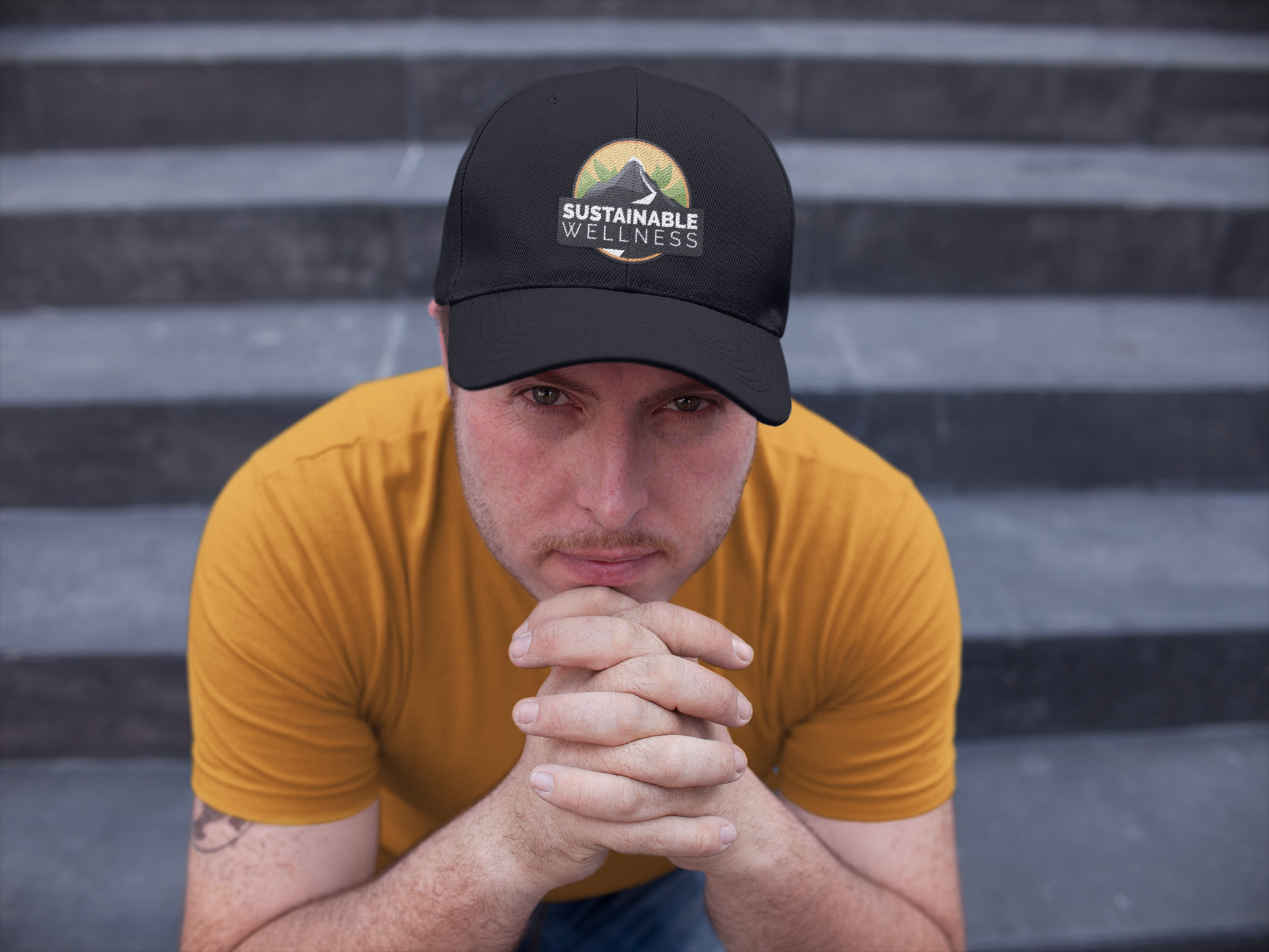 white-guy-sitting-down-on-concrete-stairs-while-wearing-a-dad-hat-mockup-a15881.png