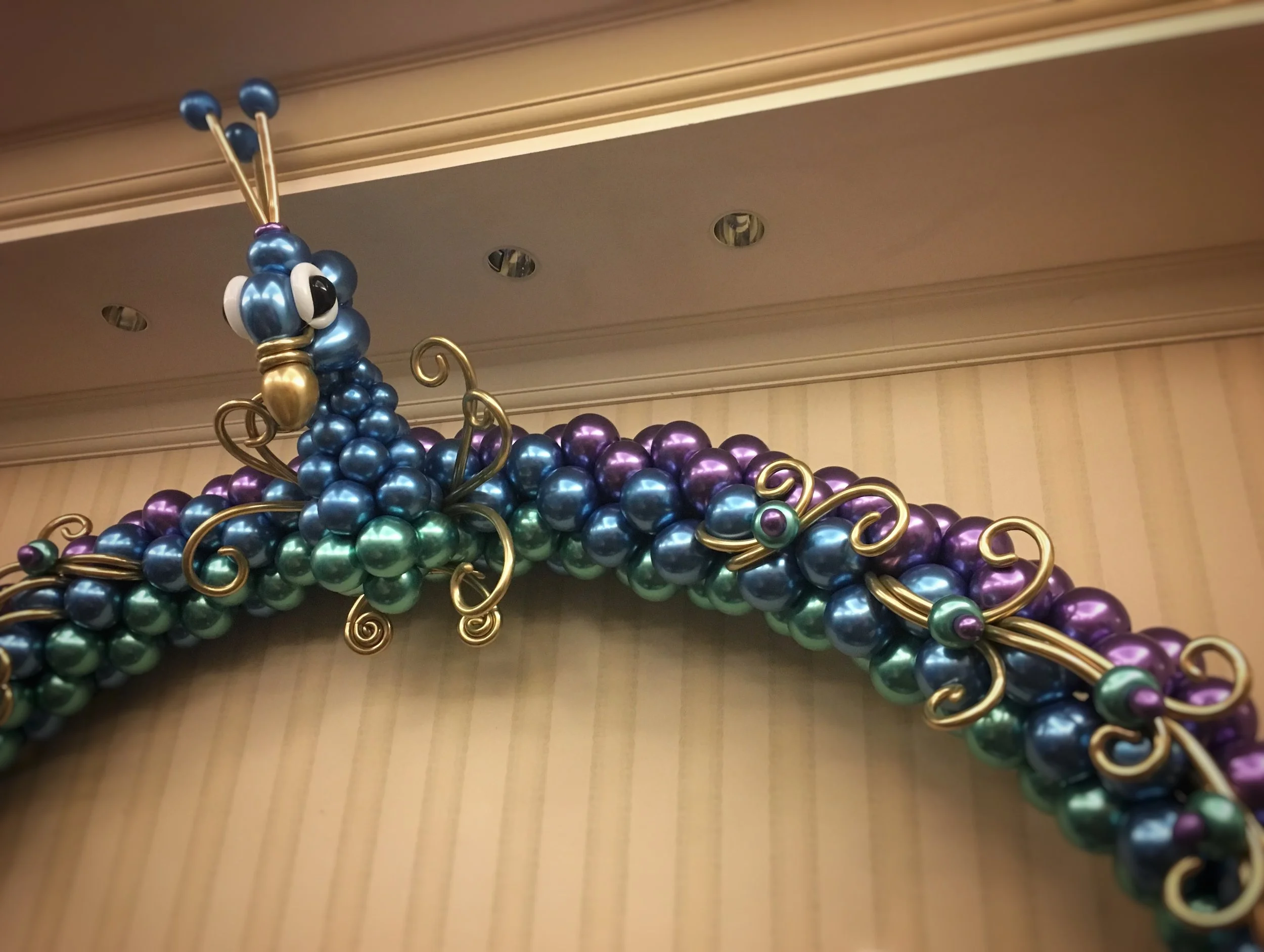 This balloon arch is pretty as a peacock.