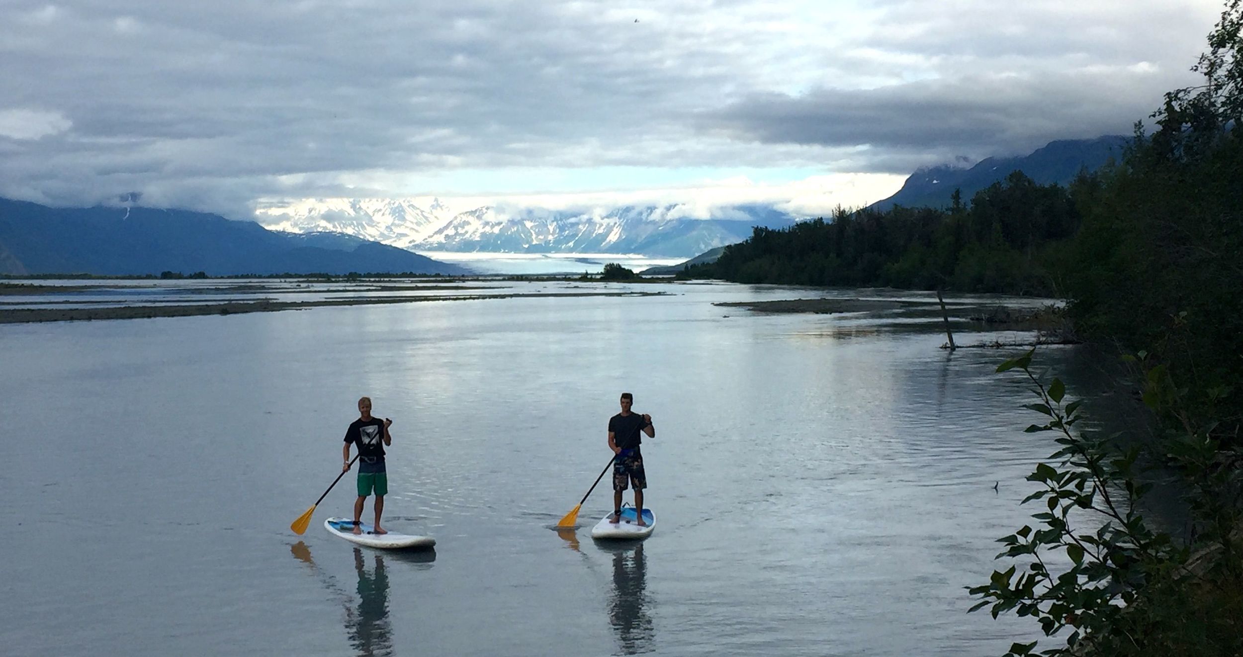 Erik and Jo taking a trip down the river on paddle boards.
