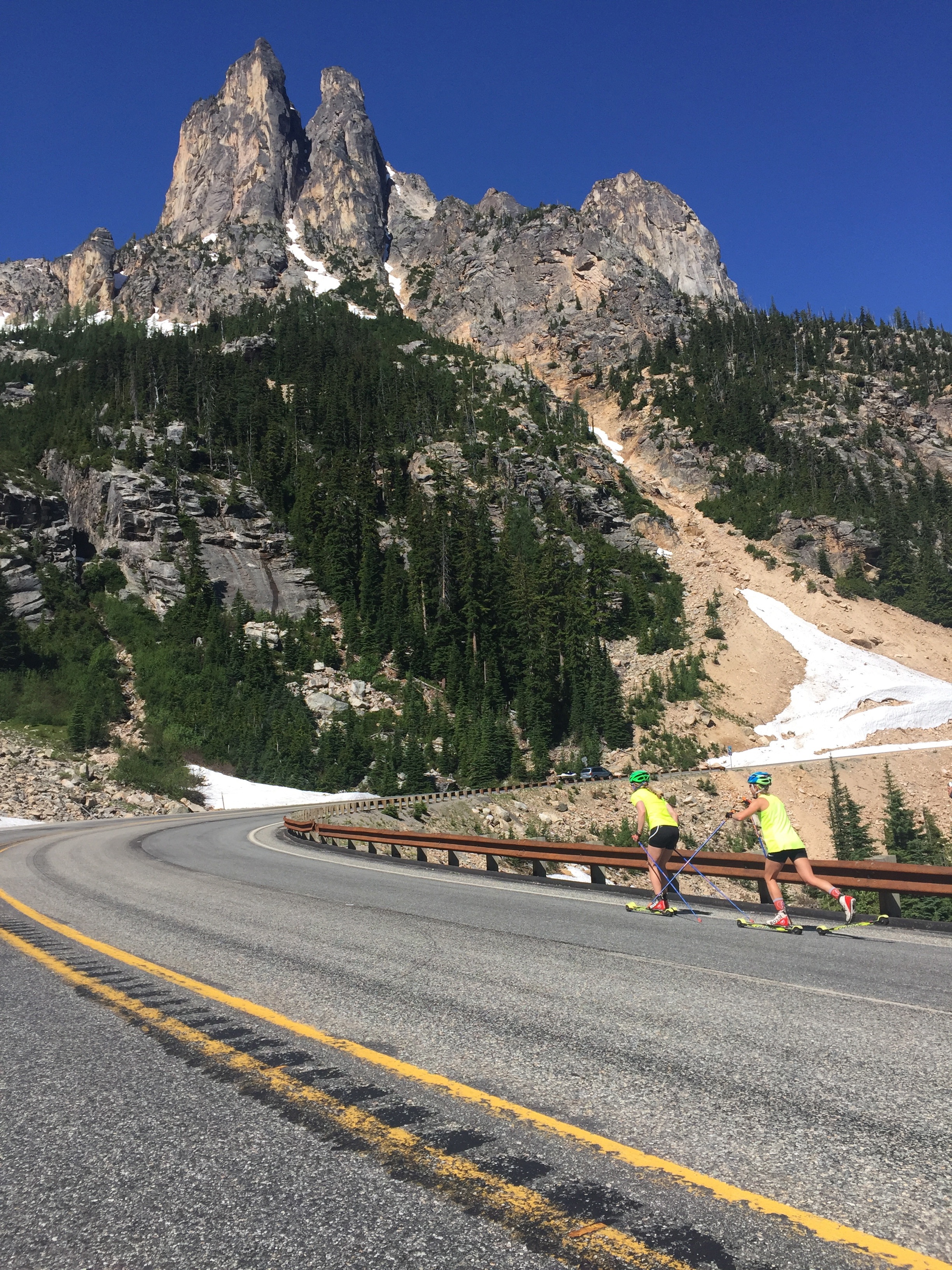 Biking alongside the girls as they rollerski up to Washington Pass.
