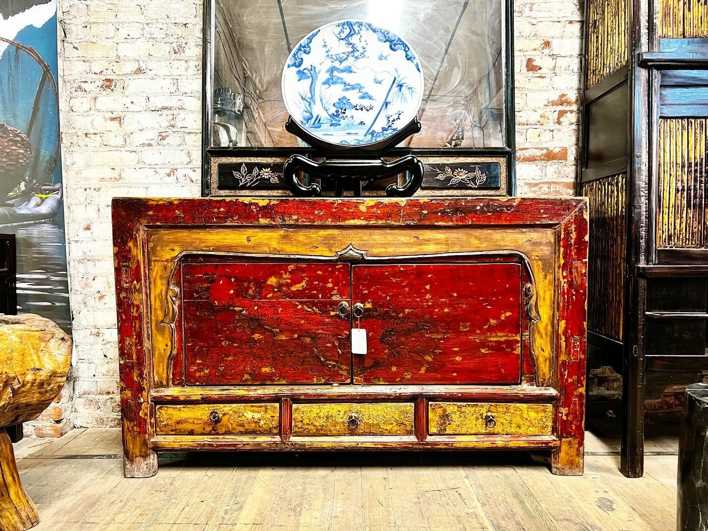 Rustic Mongolian cabinet from Ulaanbaatar. Two large doors and three drawers lacquered in an aging brick red and saffron gold. c. 1910. Dimensions: L 57&rdquo; D 18&rdquo; H 35&rdquo;. #mongolianart #mongolianfurniture #asianart #antiqueasianfurnitur